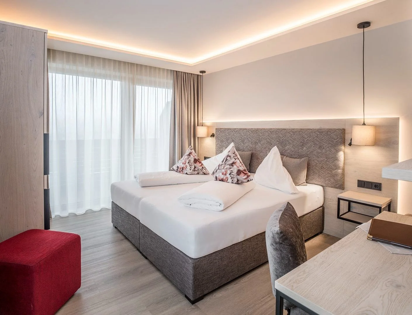 Lovely double bedroom with modern grey and white interiors. Typical Austrian mountain style but of the modern age.