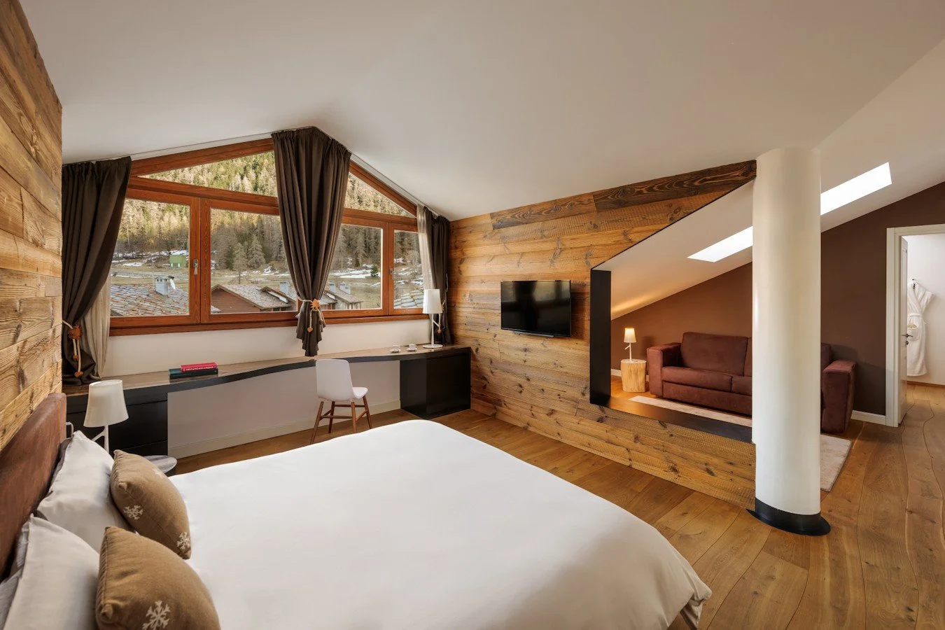 Spacious double room with alpine wood throughout. Large windows offering plenty of natural light. Large double bed with separate sofa area.