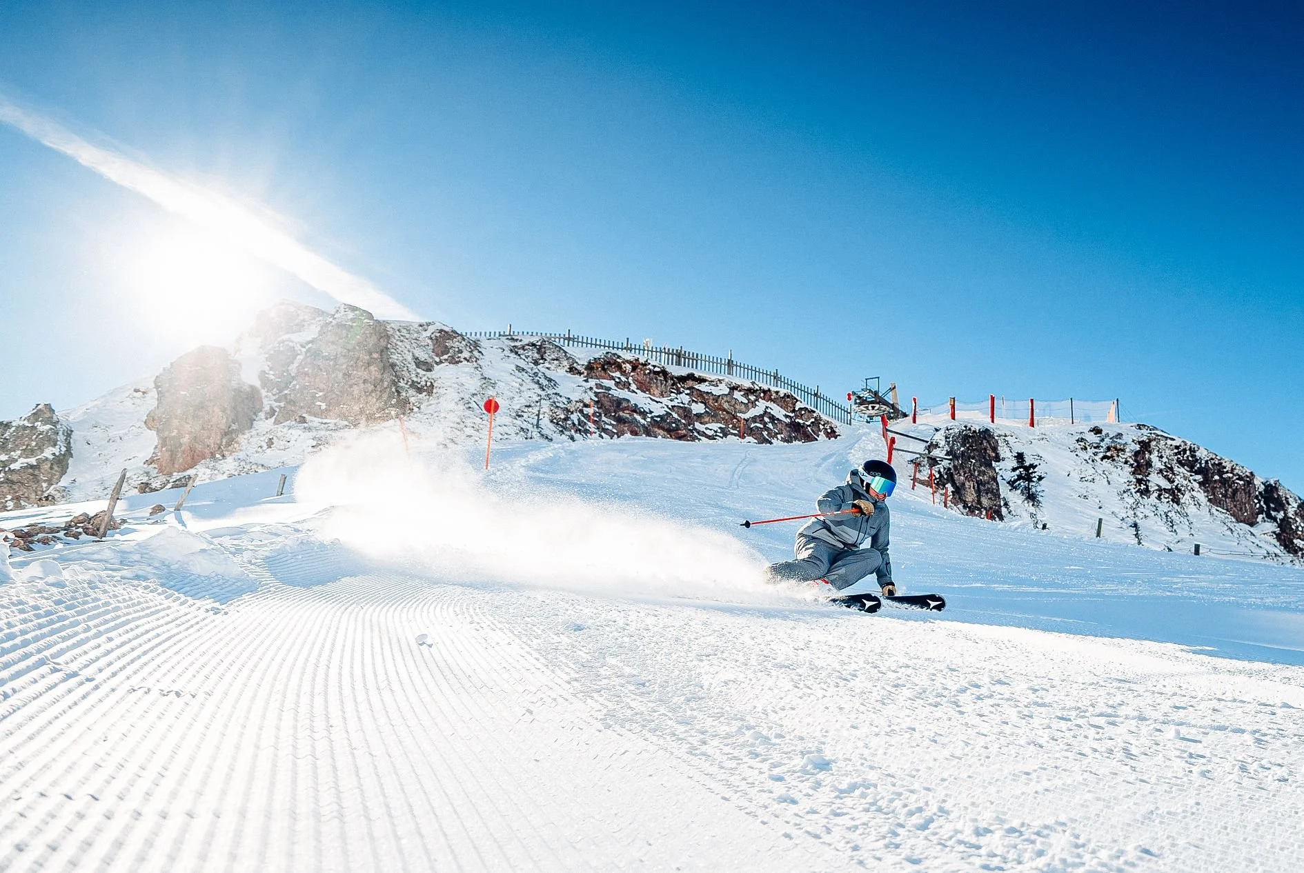 Lady skiing in Kitzbuhel with sunny conditions