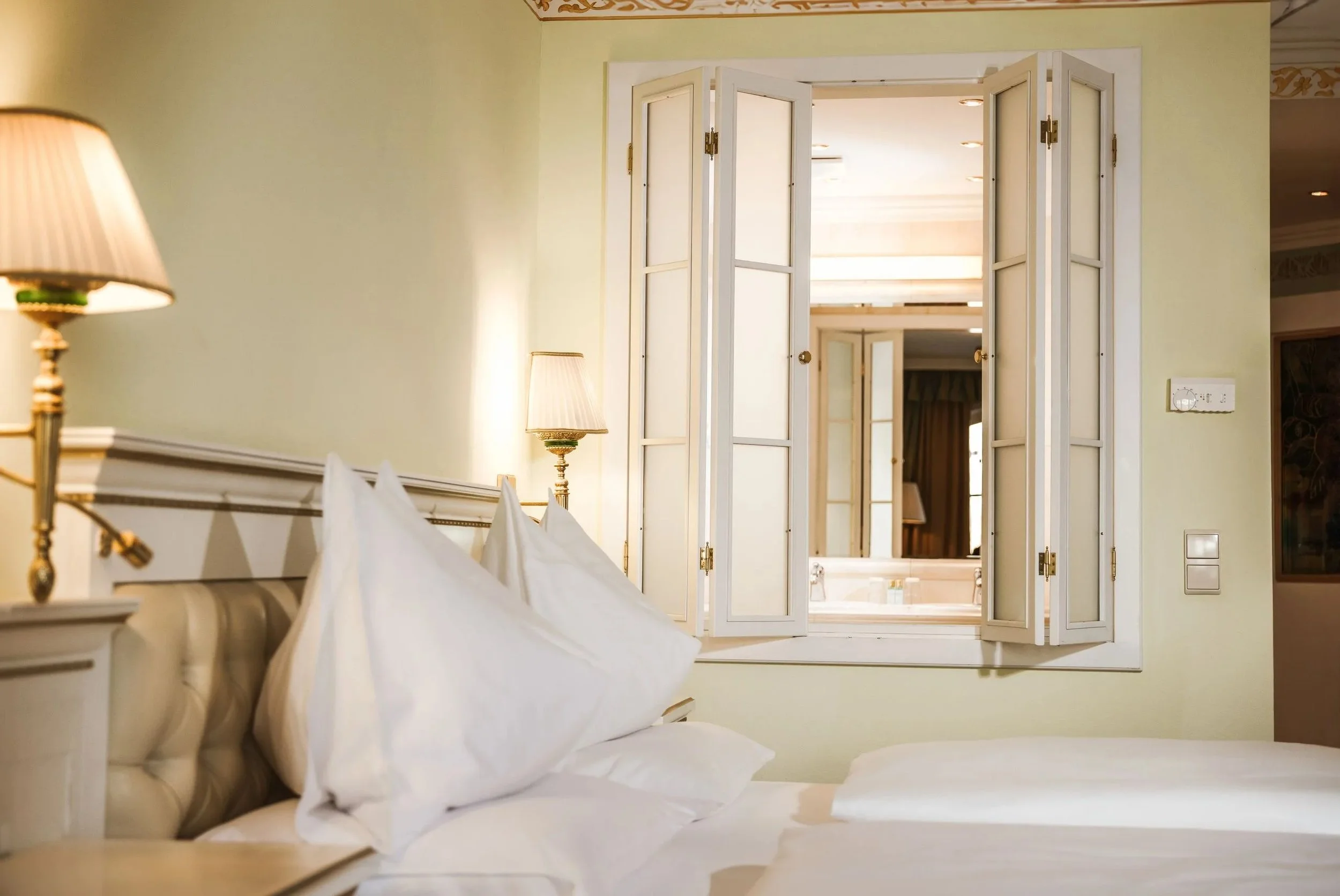 Classical style bedroom with plumb white sheets and pillows.