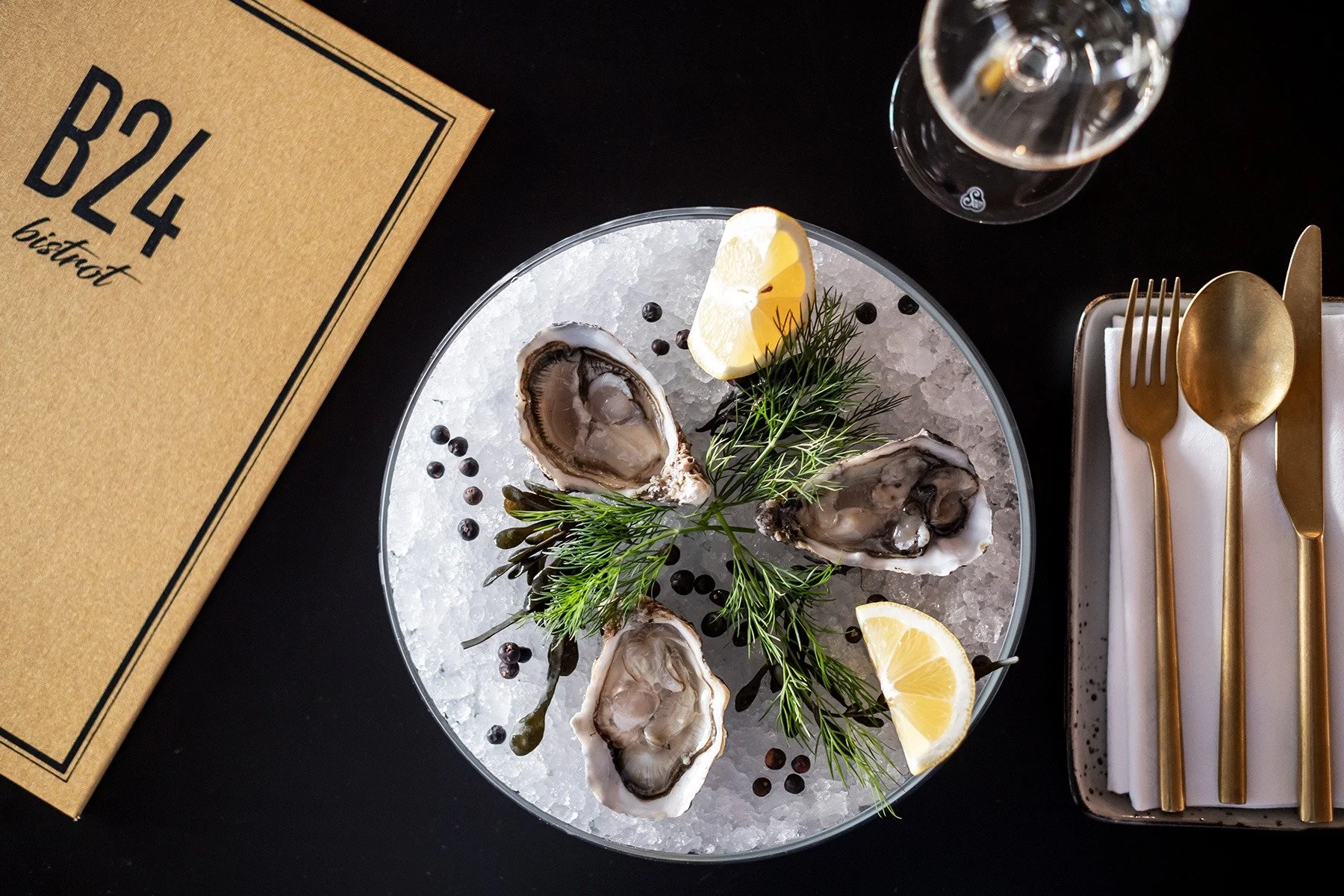 Seafood cuisine of oysters presented with lemon in the B24 Bistrot.