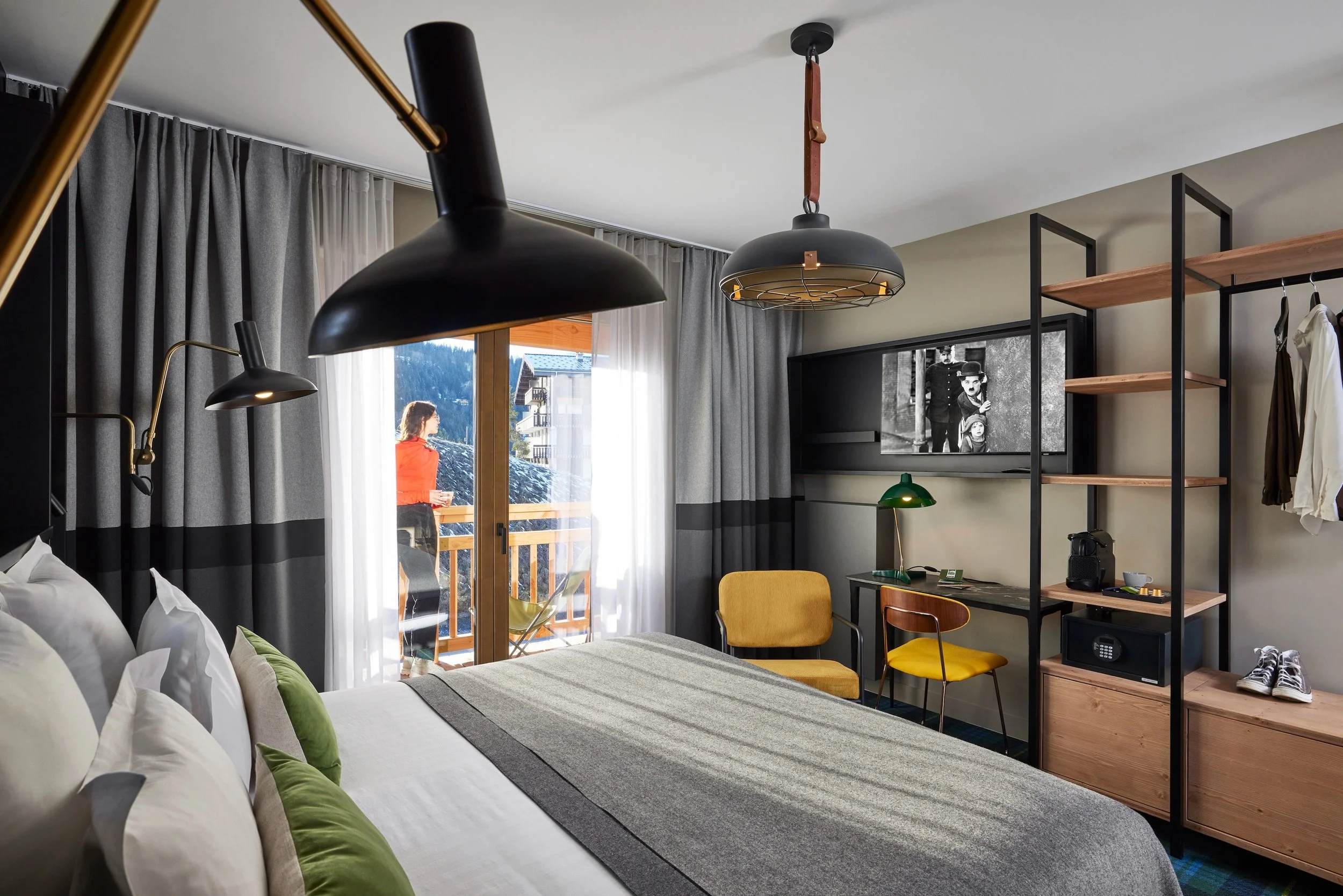 Double bedroom with balcony within the Le Chalet Alpen Valley. Plenty of storage places, TV and double bed.