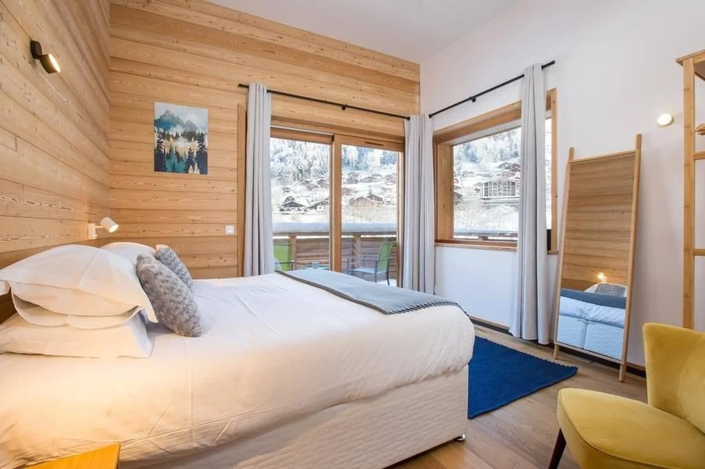 Double Bedroom in Chalet Zormine with lovely furnishings and mountain views in the distance.