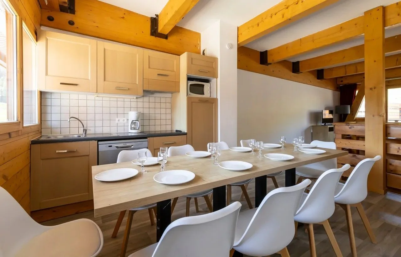 Self-catered accommodation with space around the table for 10. The kitchen is simple and classic for a ski resort but offers what the guest needs.