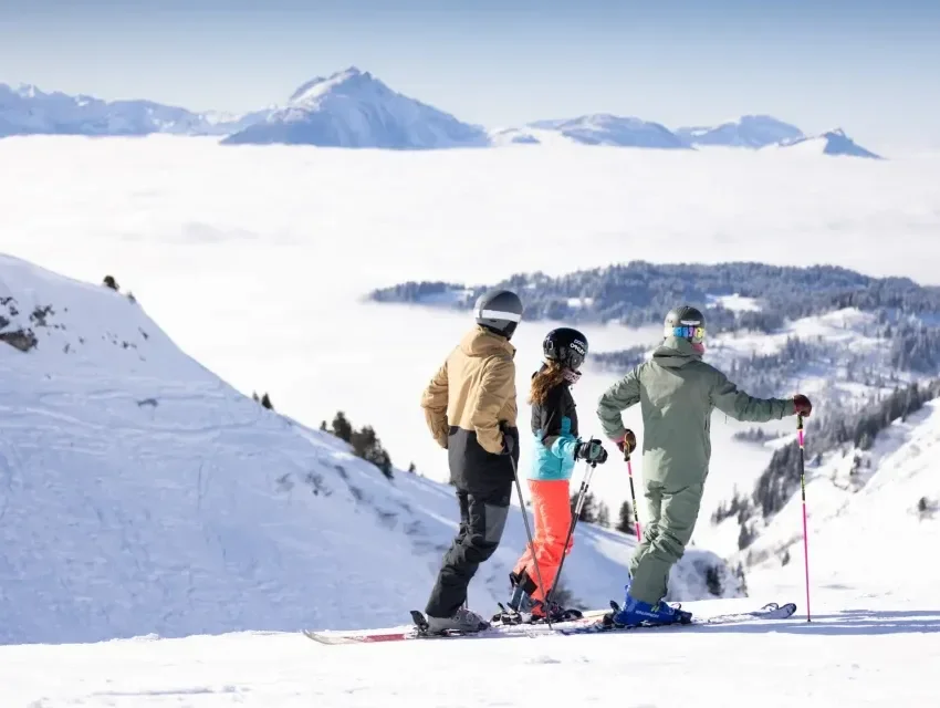 Family skiing in the Portes du Soleil area of France. Colourful outfits at the top of the mountains.