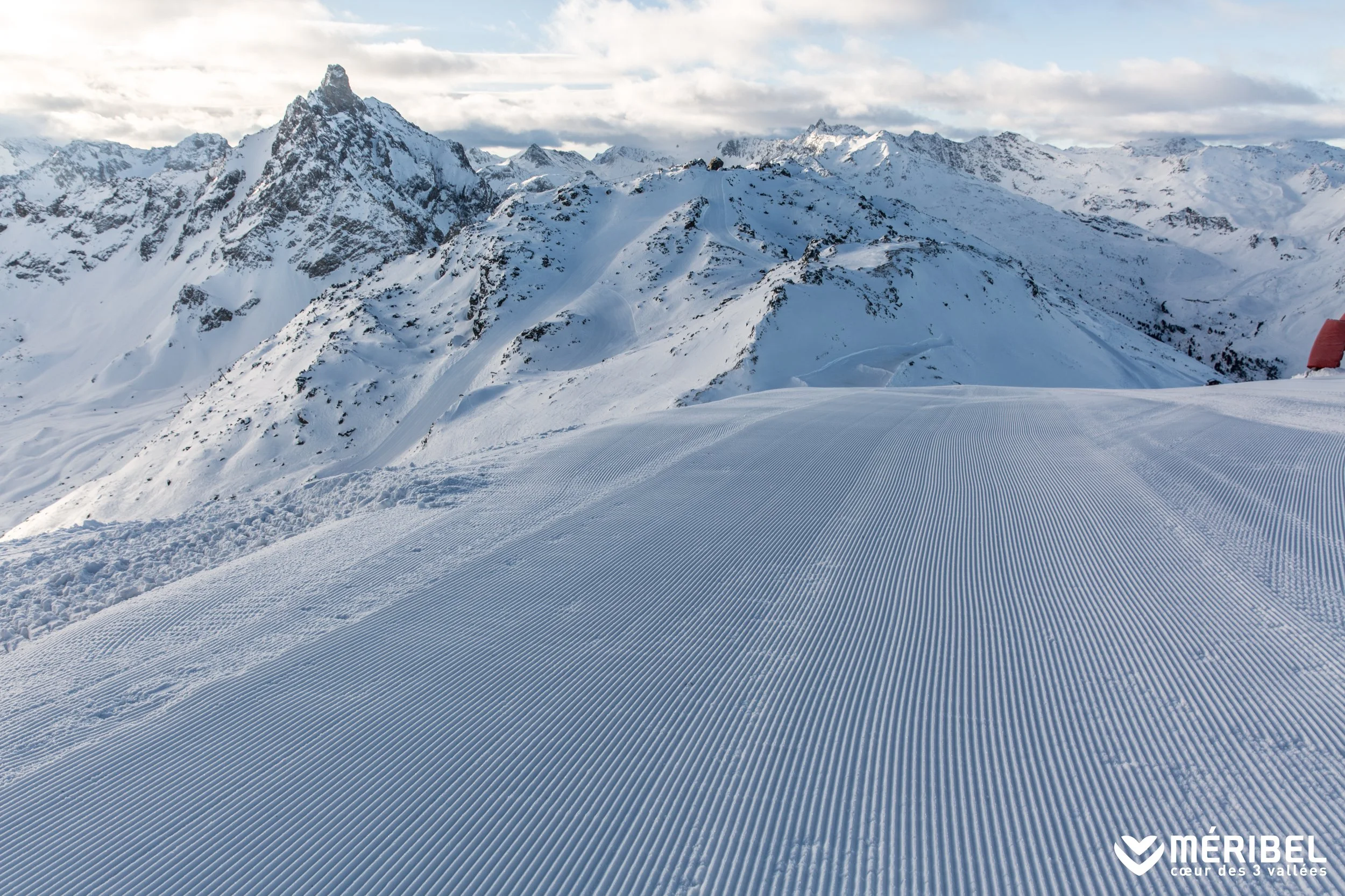 Pristine piste in the heart of Meribel, France. Freshly groomed and with the mountains in the background.