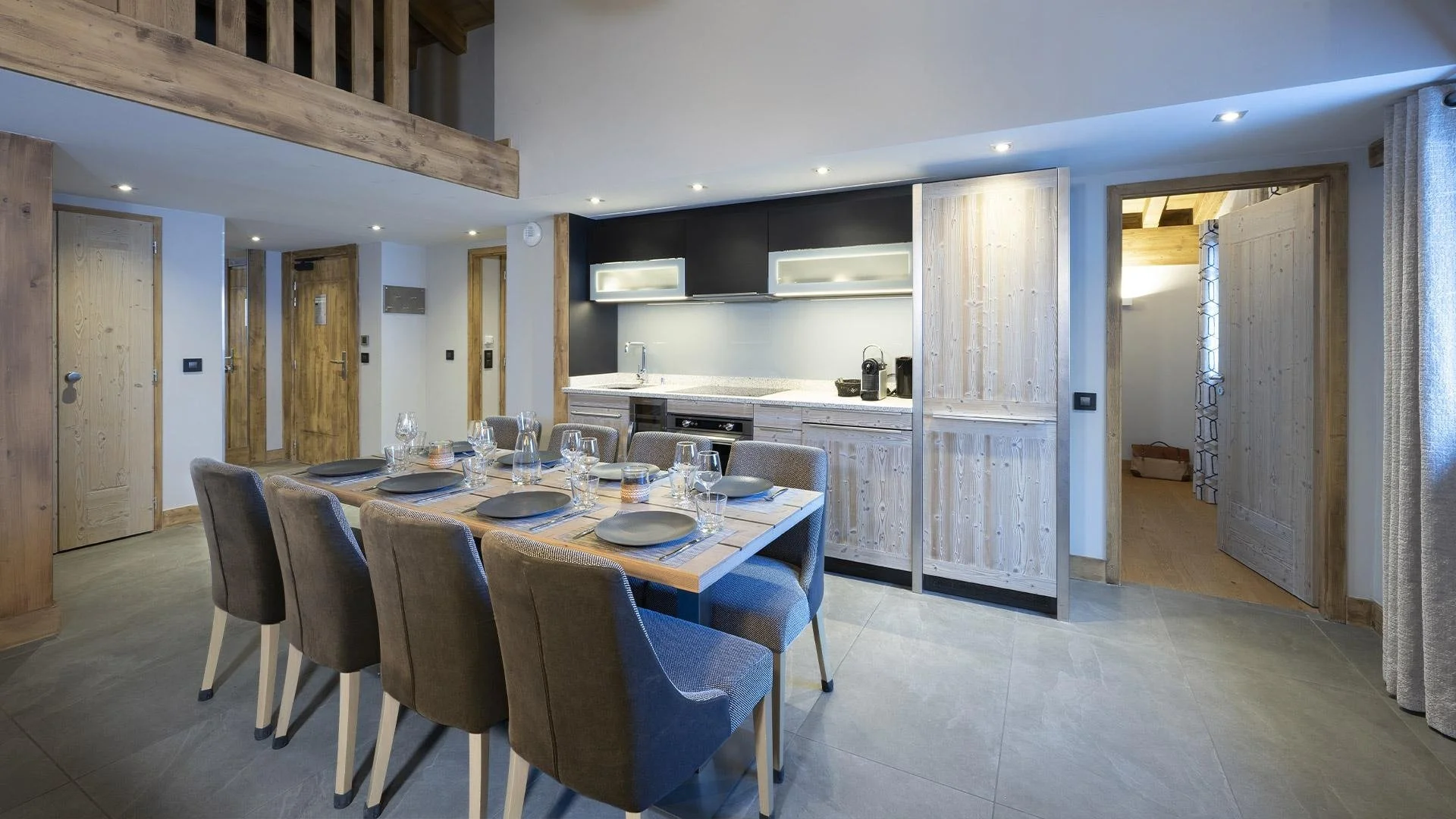 A dining table within an apartment set for 8. Self-Catered, modern and contemporary in design.