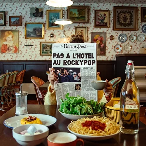 Quirky restaurant shot with plenty of art work, food and a newspaper