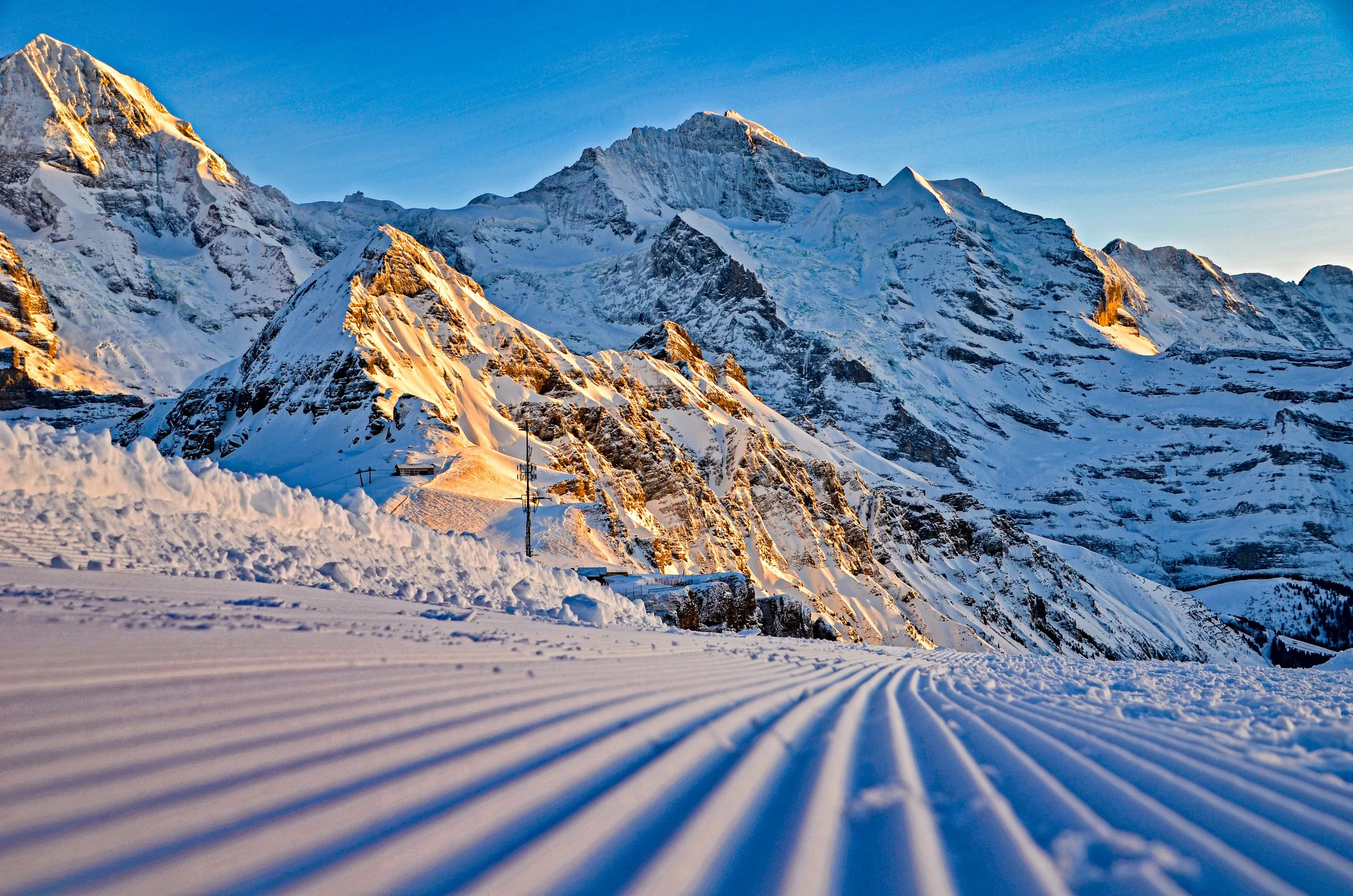 Sunrises over the slopes of Wengen creating a wonderful atmospheric moment with the peaks rising above.