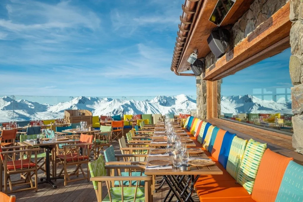 Maya Altitude, Meribel terrace. Vibrant atmosphere with colourful seating brings a buzz to the mountainous backdrop.