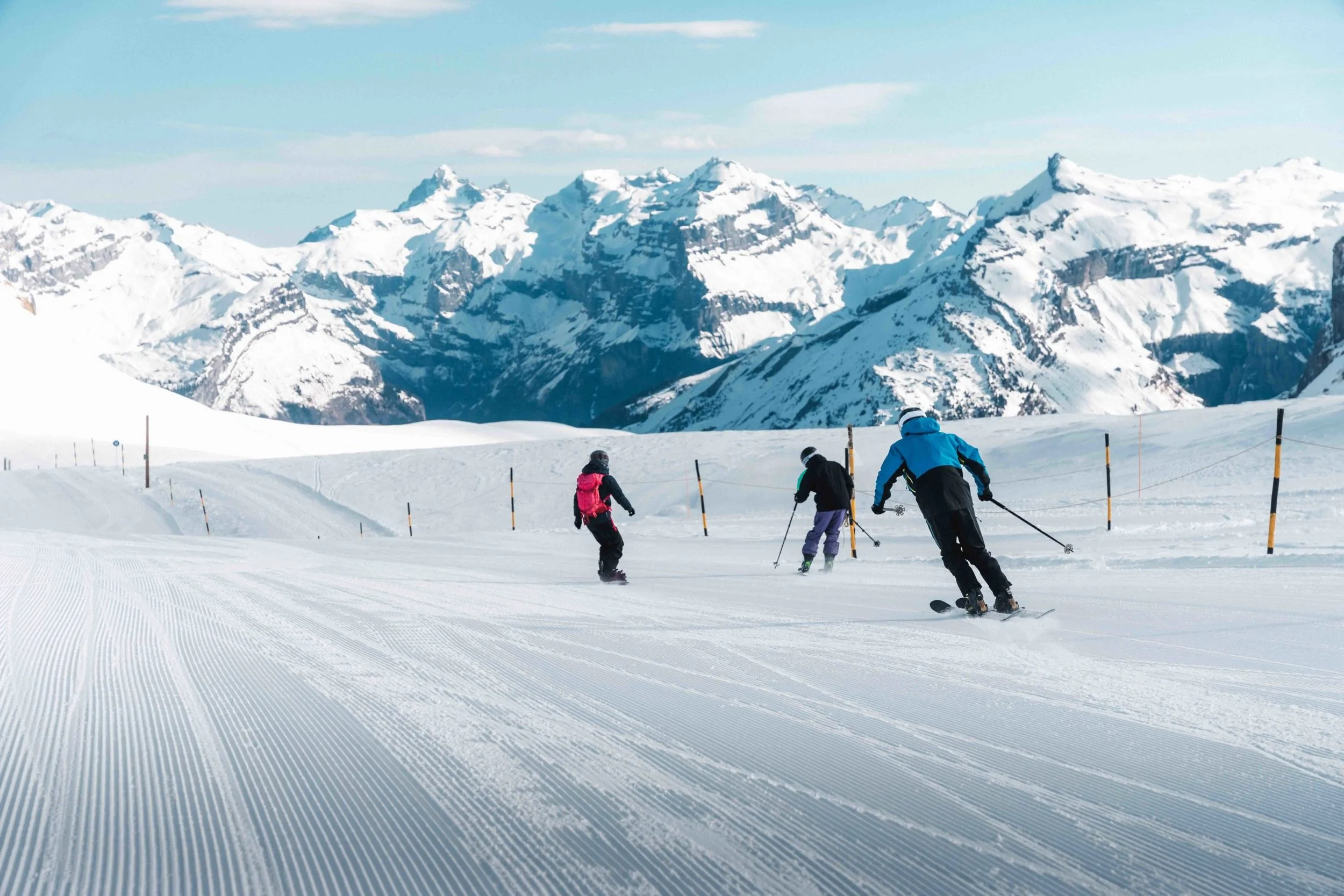 The people on the mountain. 1 Snowboarder & 2 Skiers. Blue skies and beautiful piste conditions.