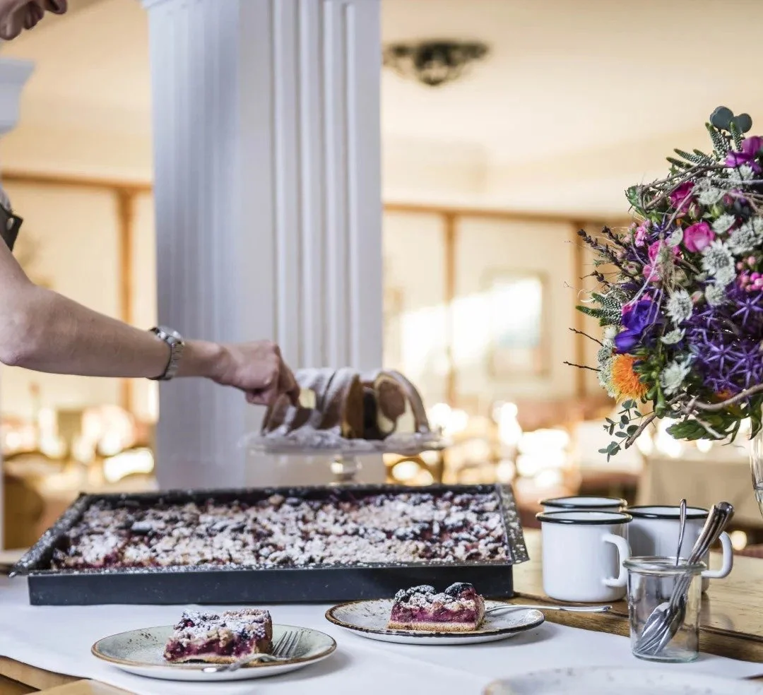 Delightful array of pudding options in Austria. A typical Tyrolean strudel with a chocolate ring in the background with marble effect.
