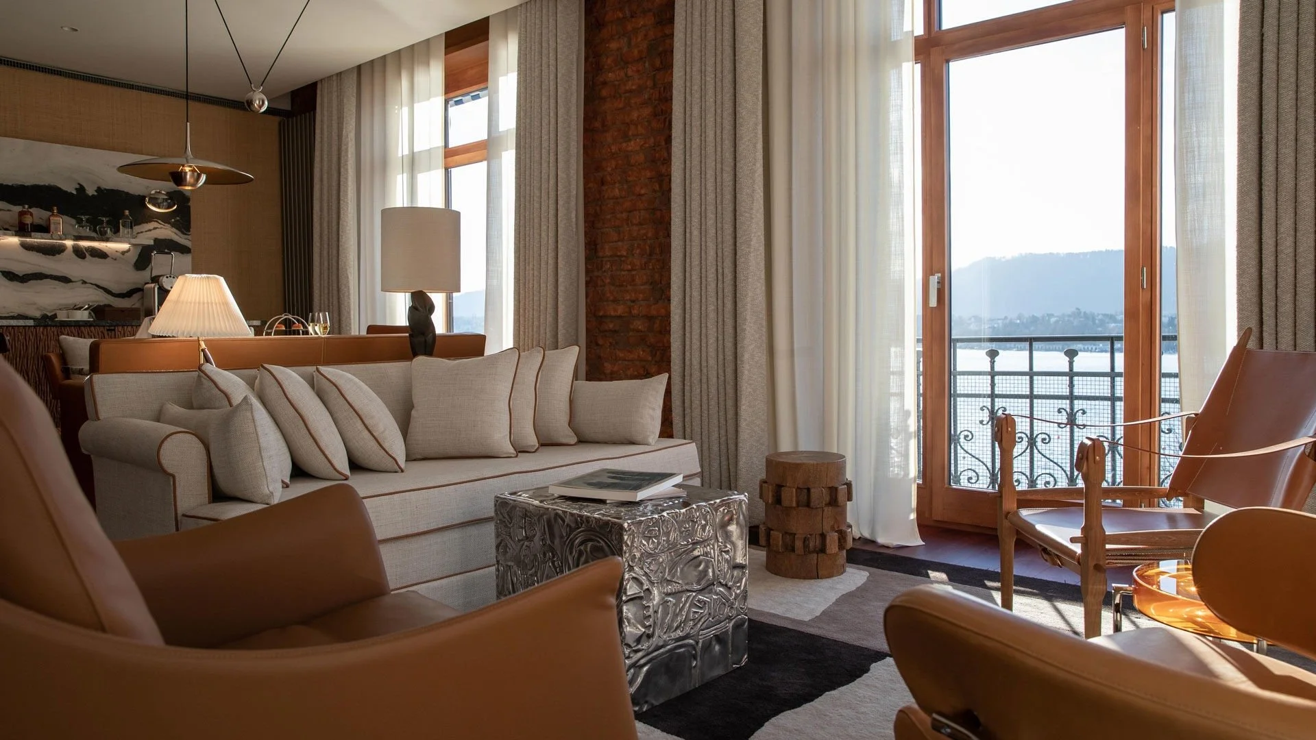 Double room at La Reserve Eden au lac Zurich. Lovely plump sofa in the suite with lakeshore views.