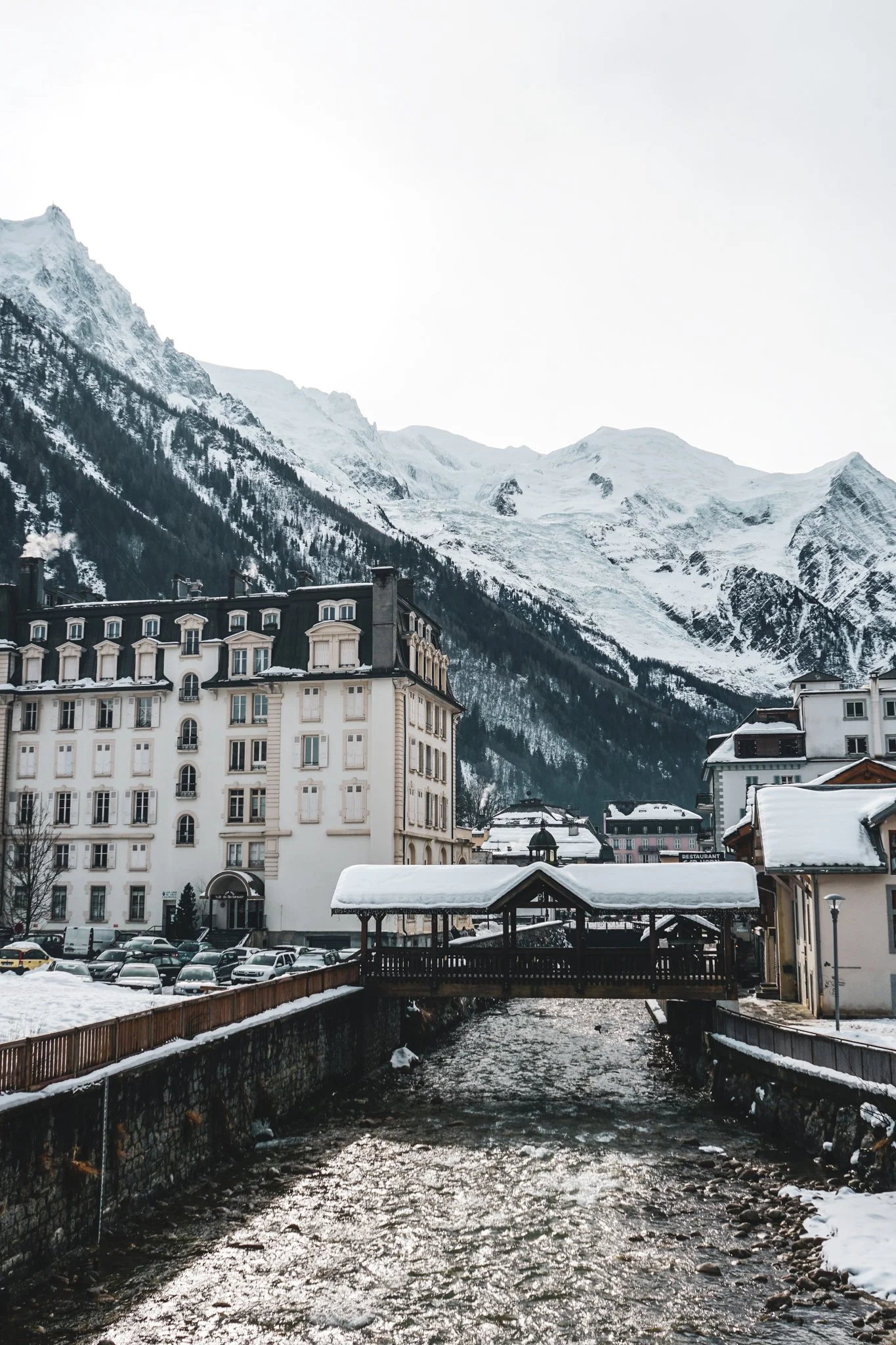 Chamonix Town Centre with the bridge crossing the river on a winters day. Mont Blanc in the background