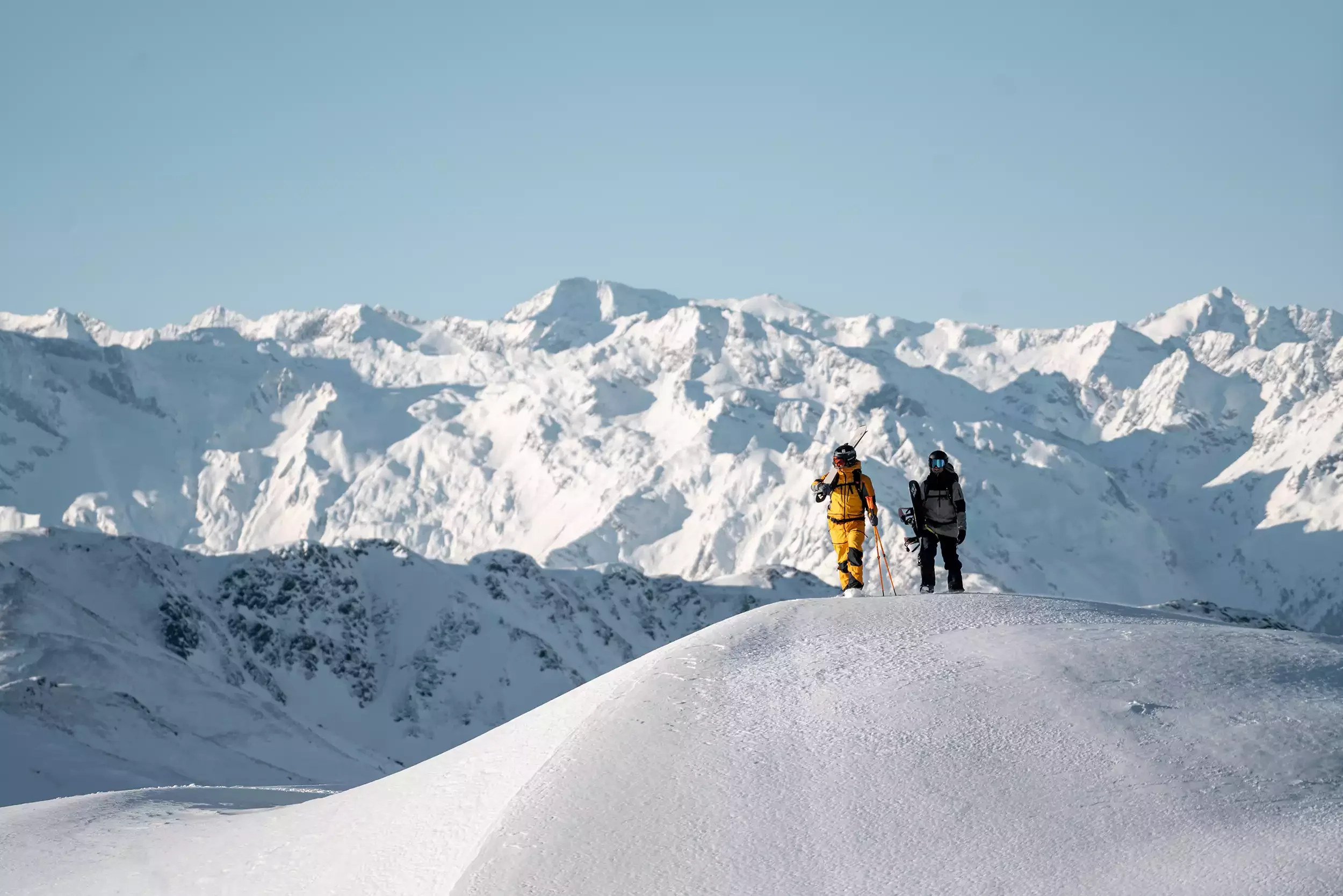 A couple of big mountain freeriders on top of the freshsnow peak.