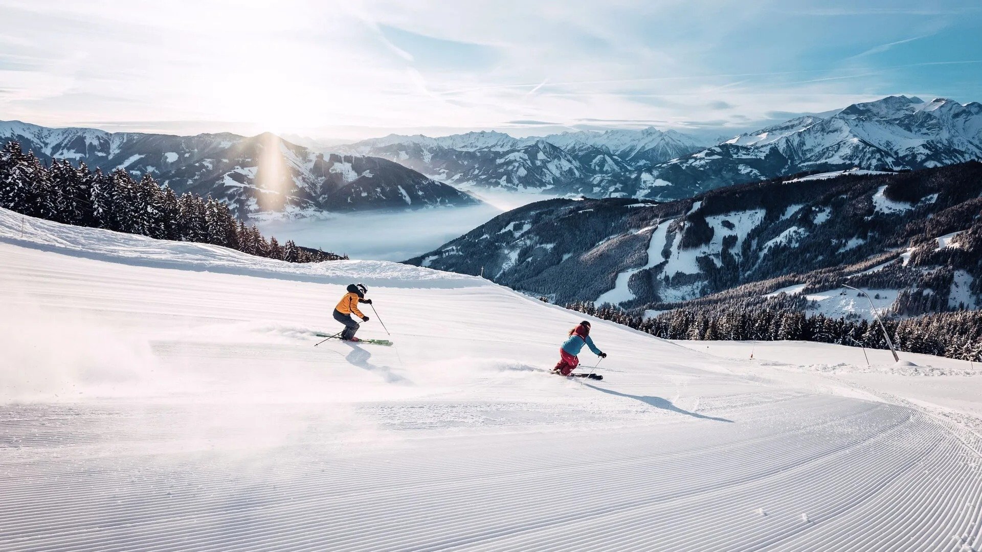 Two skiers heading down the mountain in Zell am See