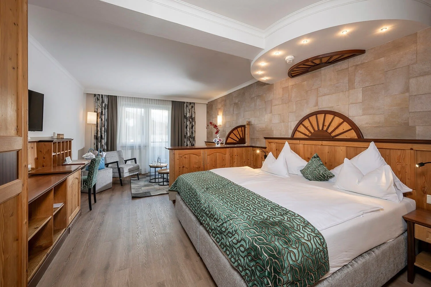 Decadent kingside double bedroom with light green notes on the bedding. Lovely bright interiors with alpine wood and modern design.