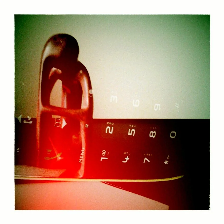 Close-up of a child's toy phone with colorful buttons and an image of a girl holding a basket.