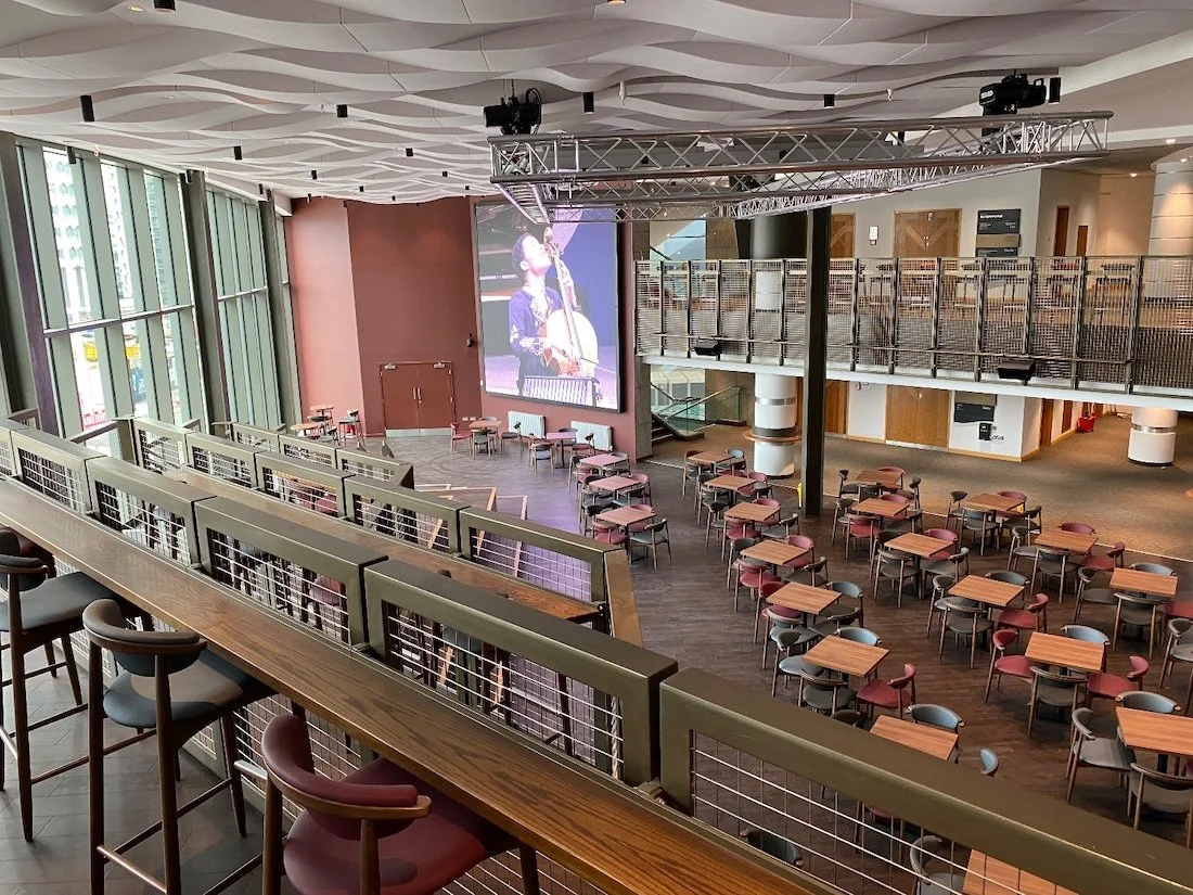 Balcony area in a large entertainment building, looking down on a performing area.