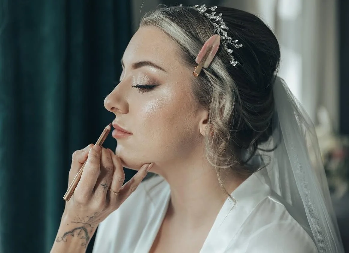 Another beautiful bride with a hair clip and a veil, getting her makeup applied by Kelly Marie
