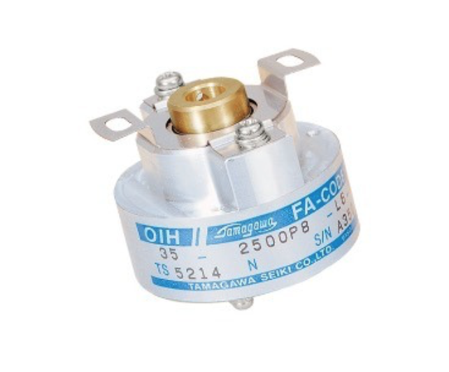 Close-up of an encoder with a white and blue label and a gold top.