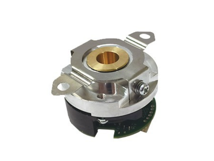 Close-up of an absolute encoder with metal and circuit parts.