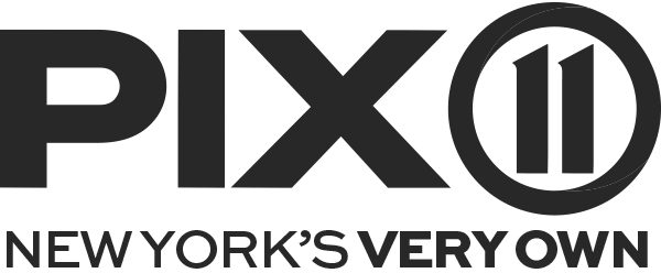 A black and white cityscape with tall buildings and a cloudy sky.