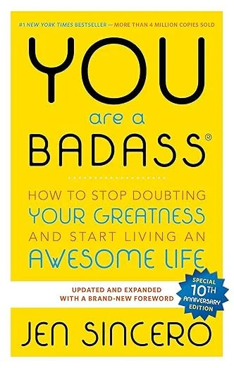 Book cover titled 'You Are a Badass' by Jen Sincero with yellow background, black and blue text, encouraging readers to stop doubting their greatness and start living an awesome life.