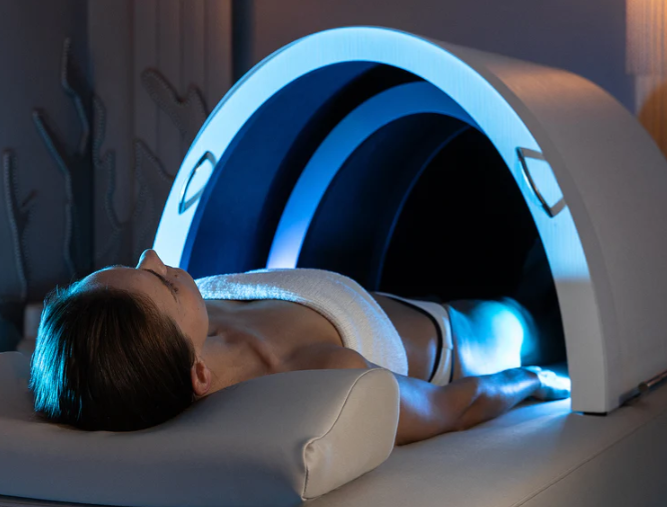 A woman lying on her back inside a medical imaging MRI machine, preparing for the procedure.