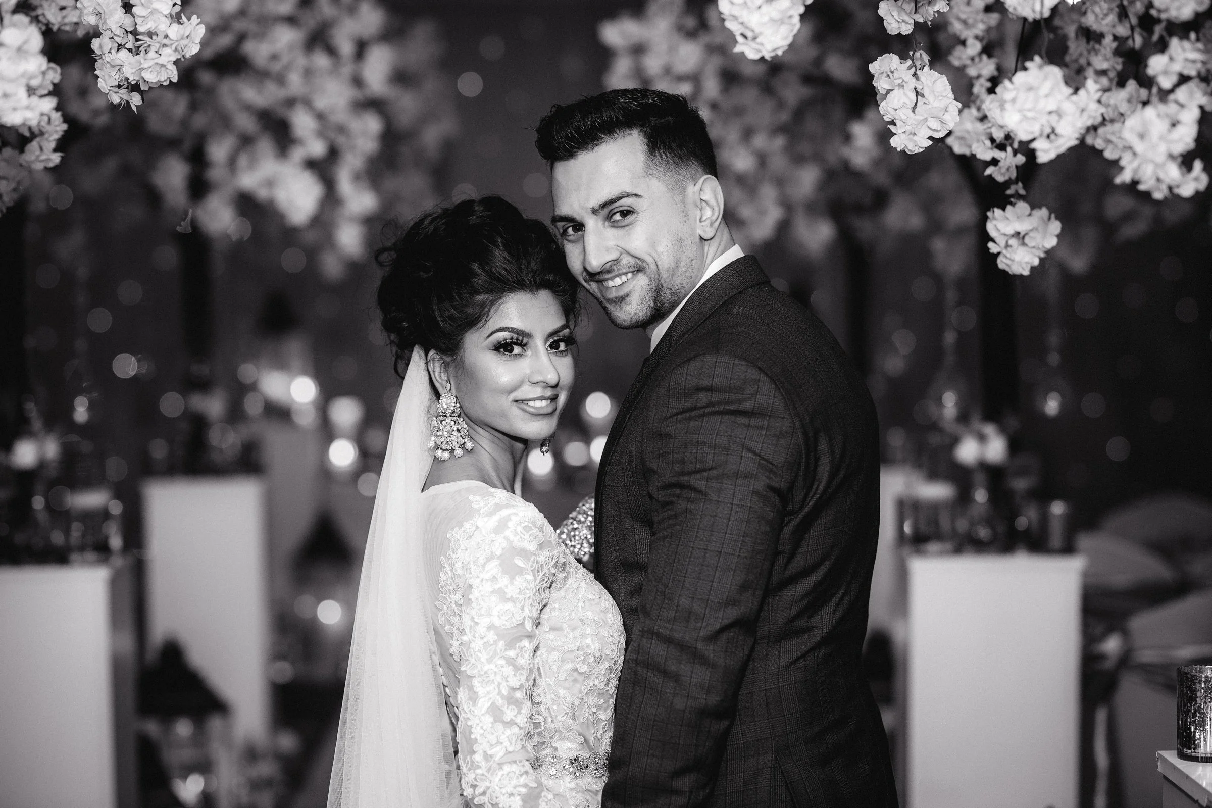Brdie and groom facing the viewer with big smiles on their faces in the ceremony room