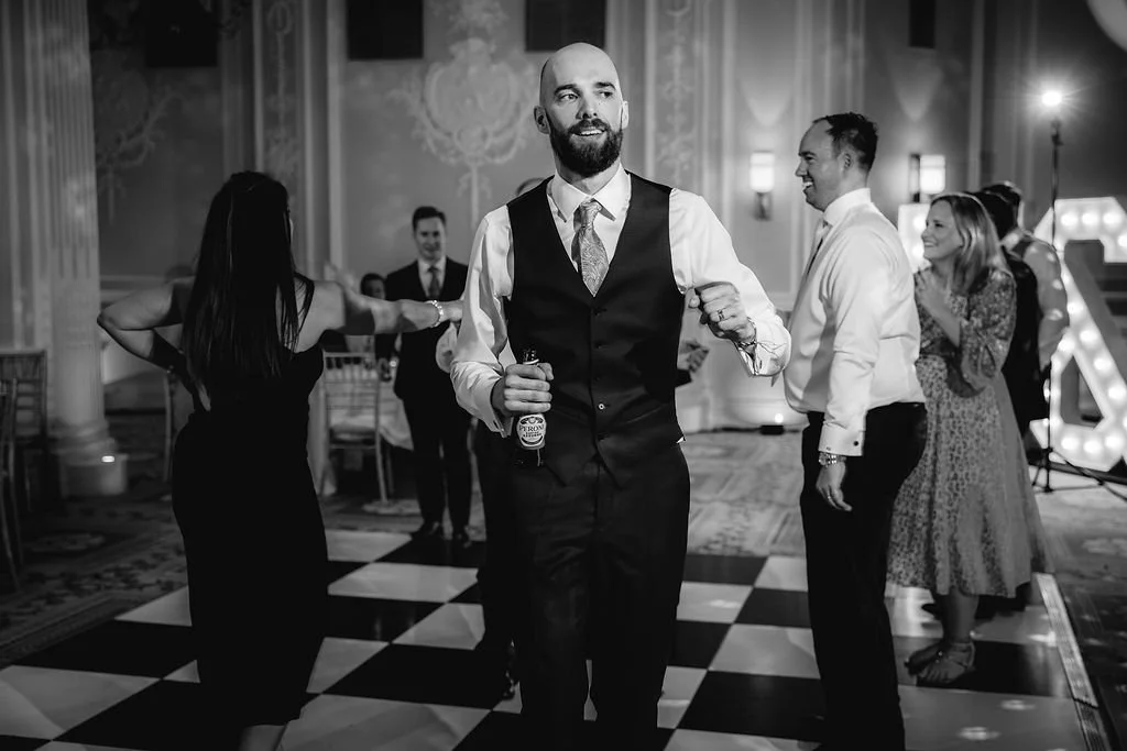 People dancing at a formal event or wedding reception in an elegant ballroom