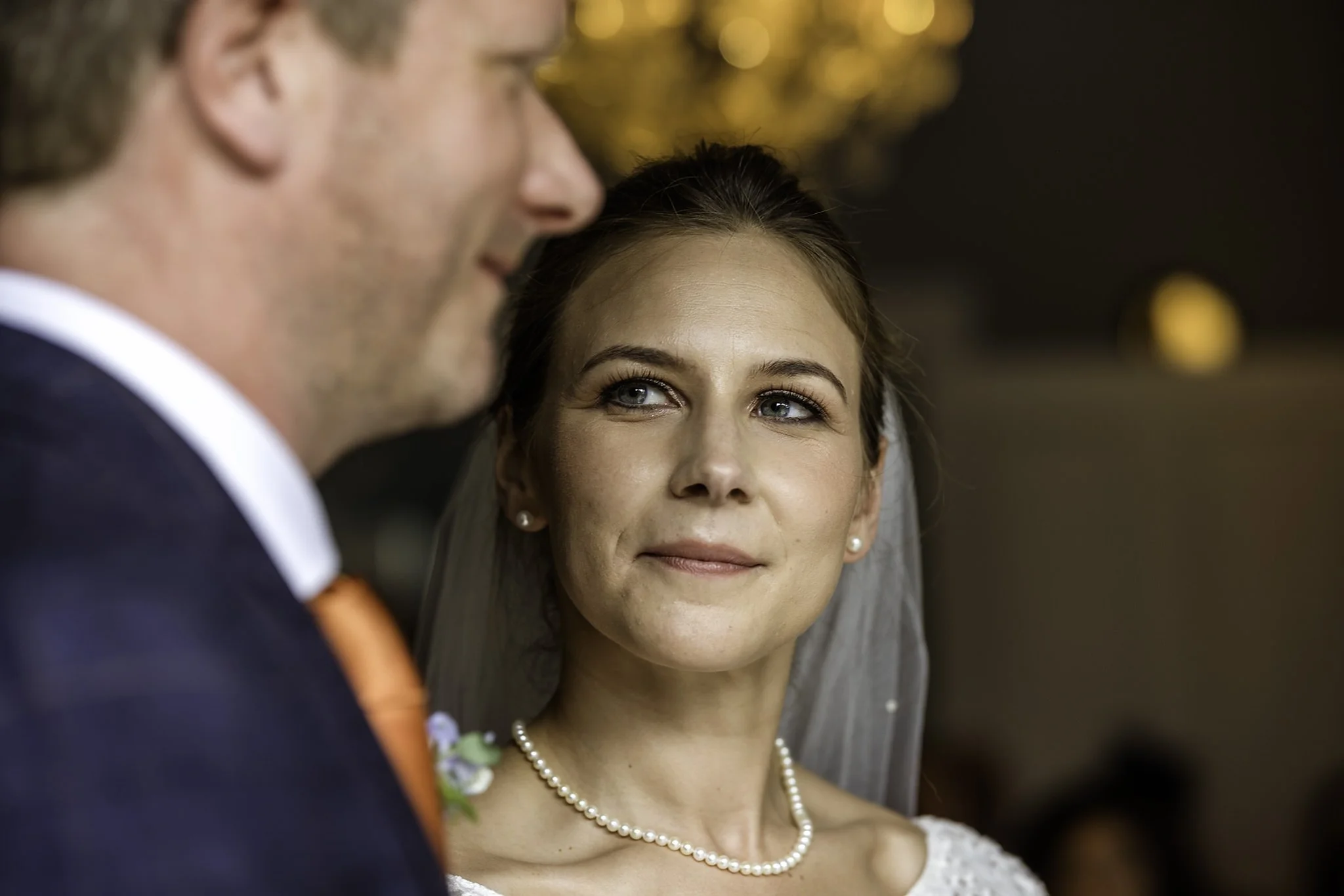 Close up of a brides loving expression as she looks at her groom during the wedding ceremony.