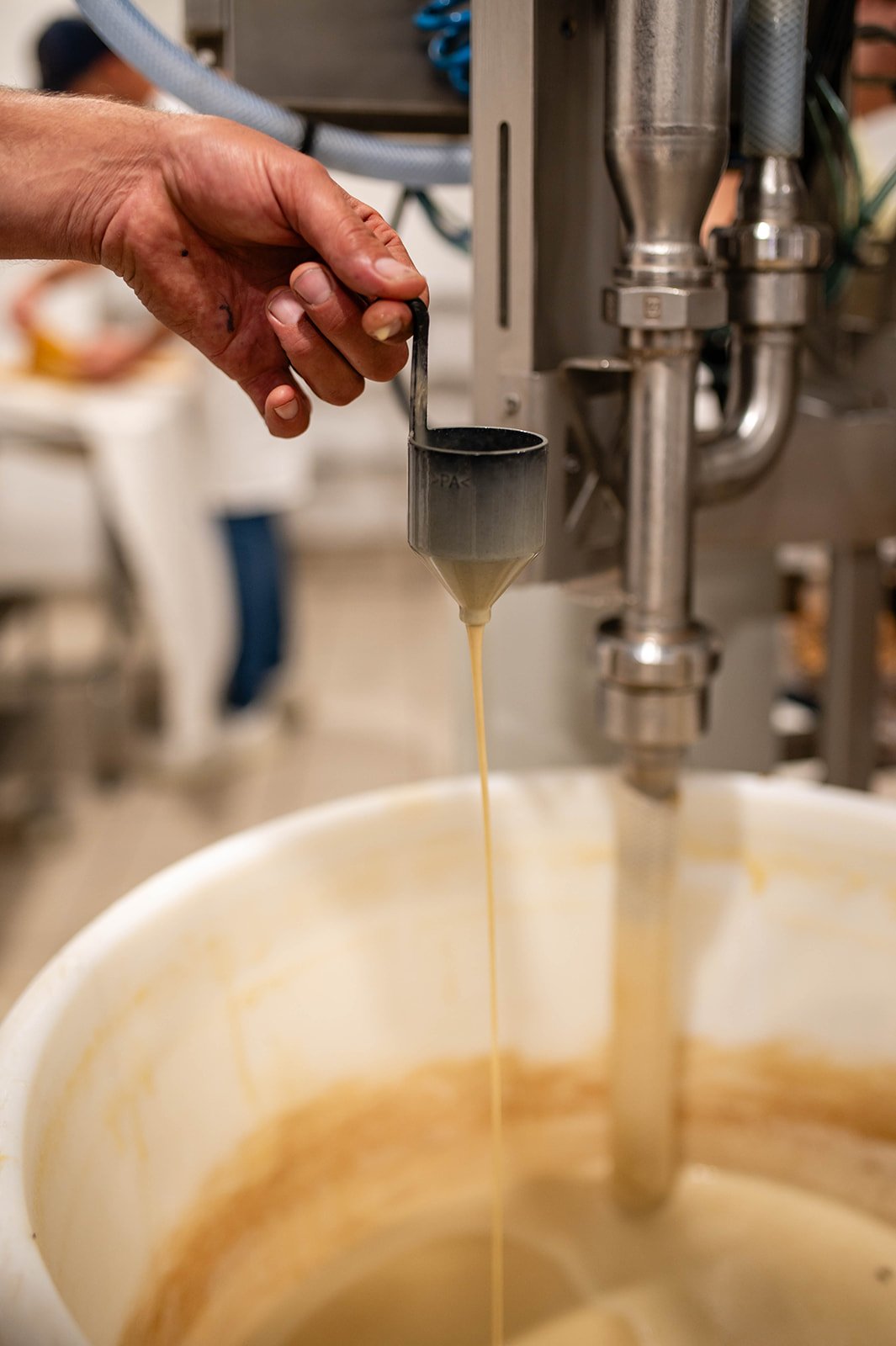 Hand pouring beer from the beer machine into a glass.