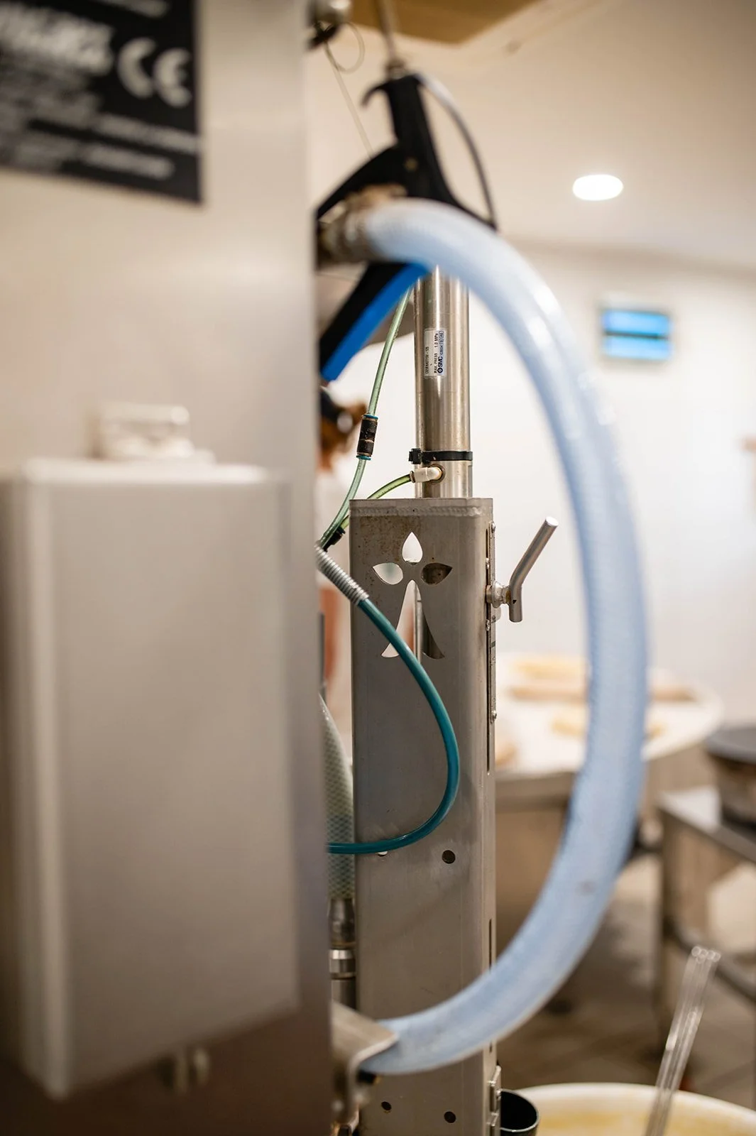 A kitchen appliance with PVC tubes and metal components, in a room with soft lighting.