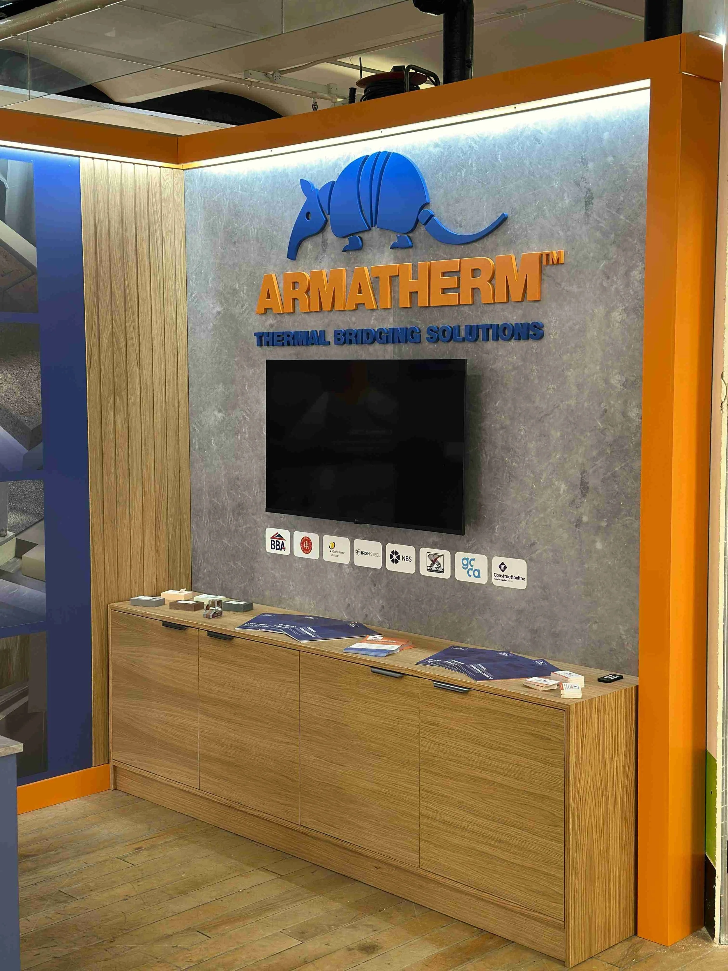 Armatherm branded exhibition display wall with TV, product samples and bespoke joinery at Masson Mills