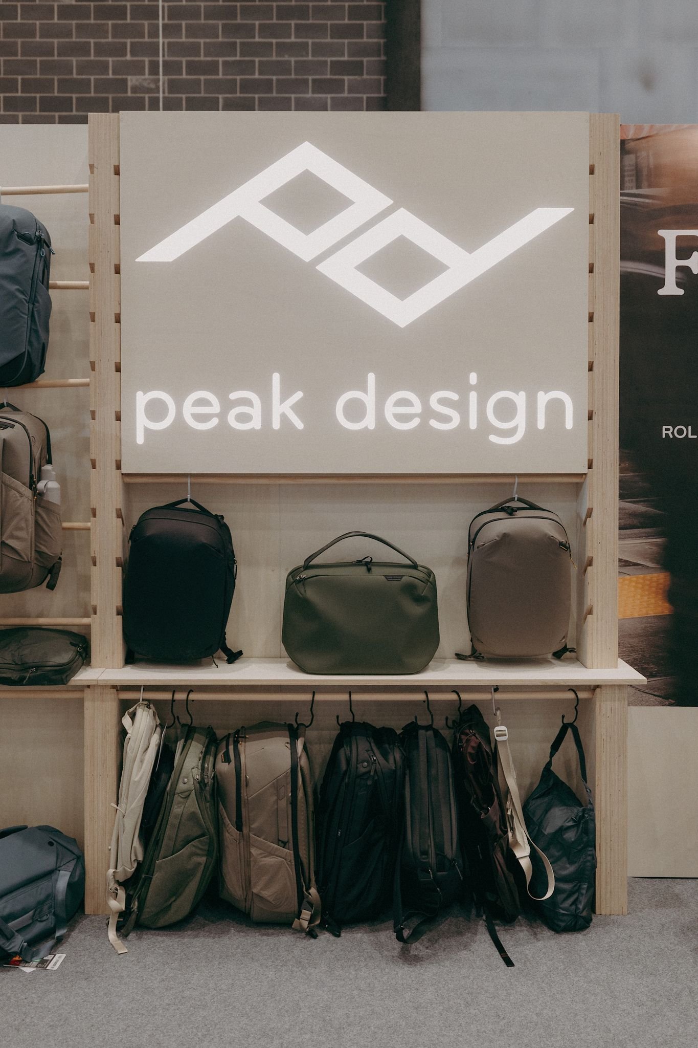 Illuminated Peak Design logo display on a modular exhibition stand at the Outdoor Trade Show