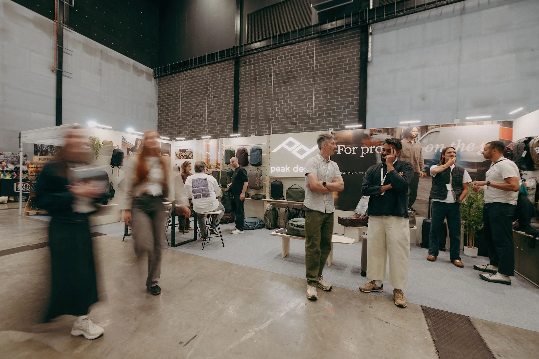 Peak Design exhibition stand at Liverpool Exhibition Centre with visitors exploring the product range