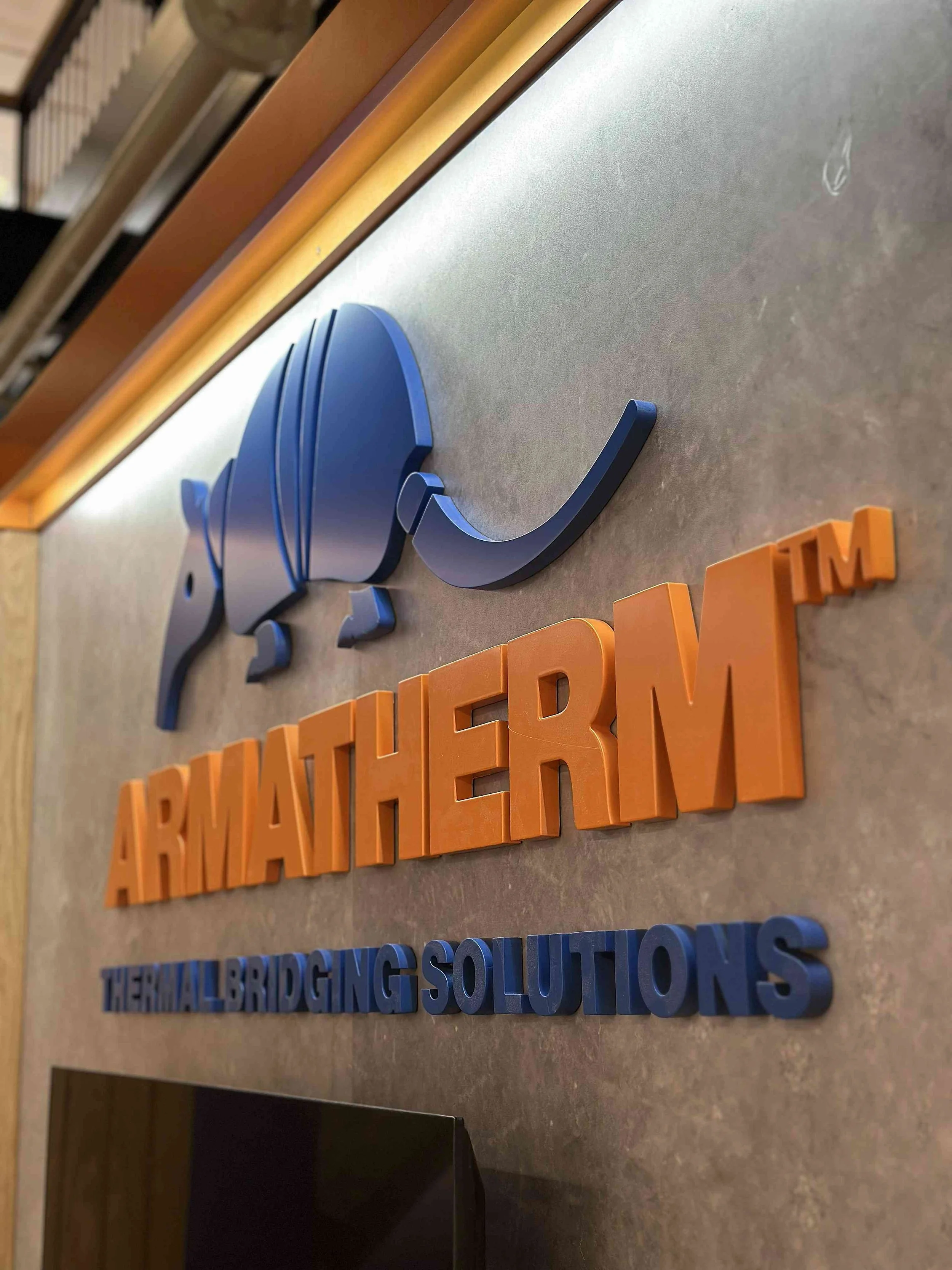 Close-up of Armatherm 3D logo signage on a bespoke permanent exhibition stand