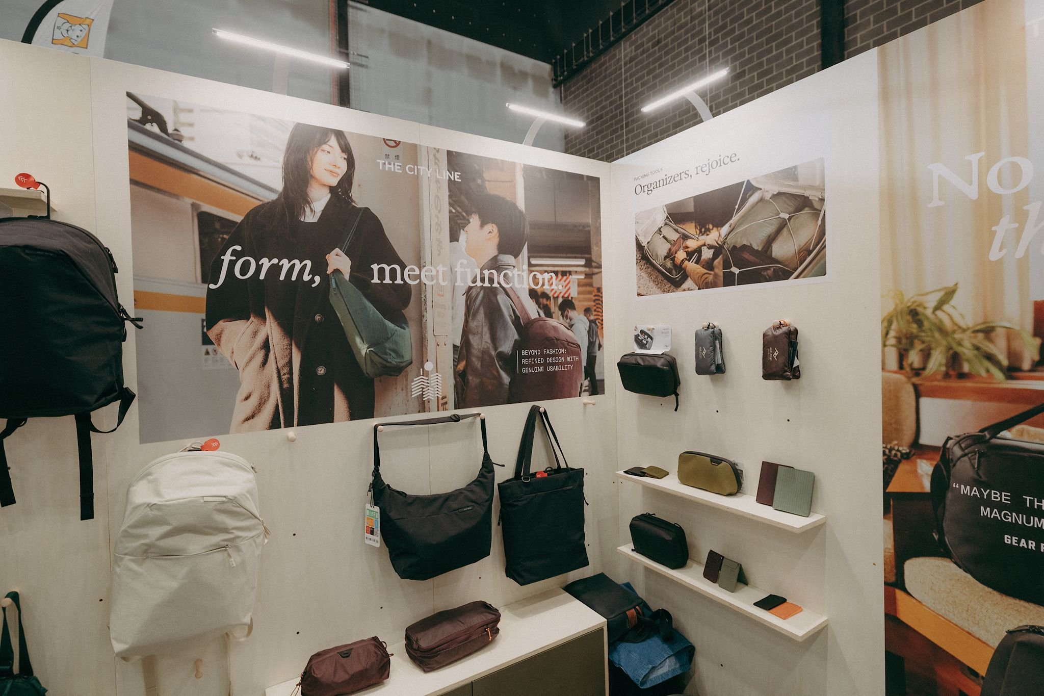 Peak Design modular trade show stand with branded graphics, product displays and travel accessories