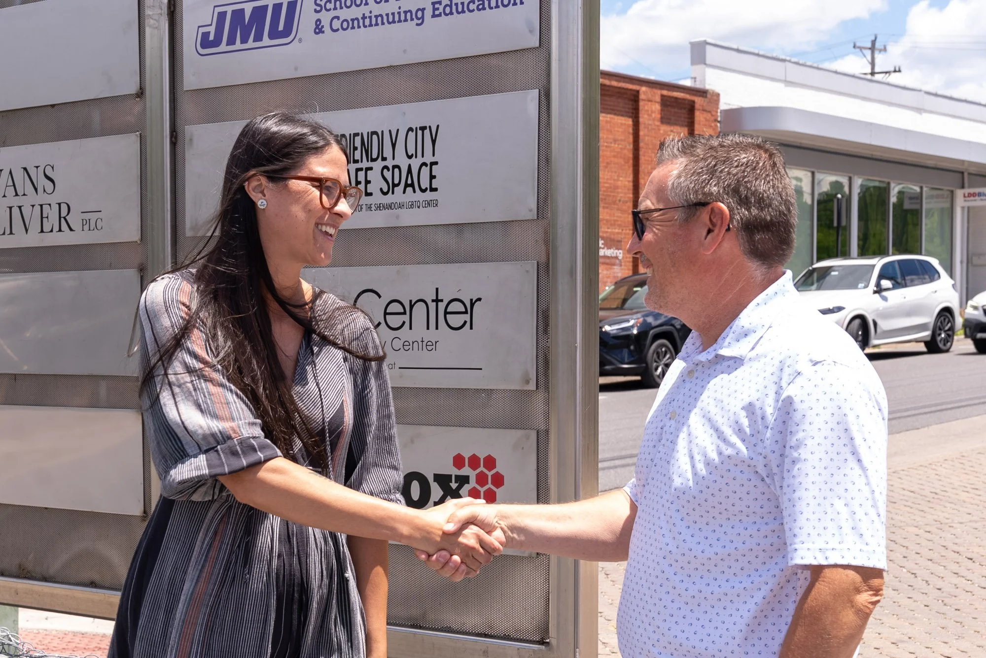 a female employee from the collins center shaking hands with an LD&B representative