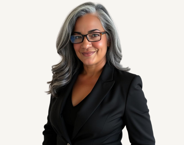 A woman with long gray hair, glasses, and a warm smile, wearing a black blazer against a plain white background.