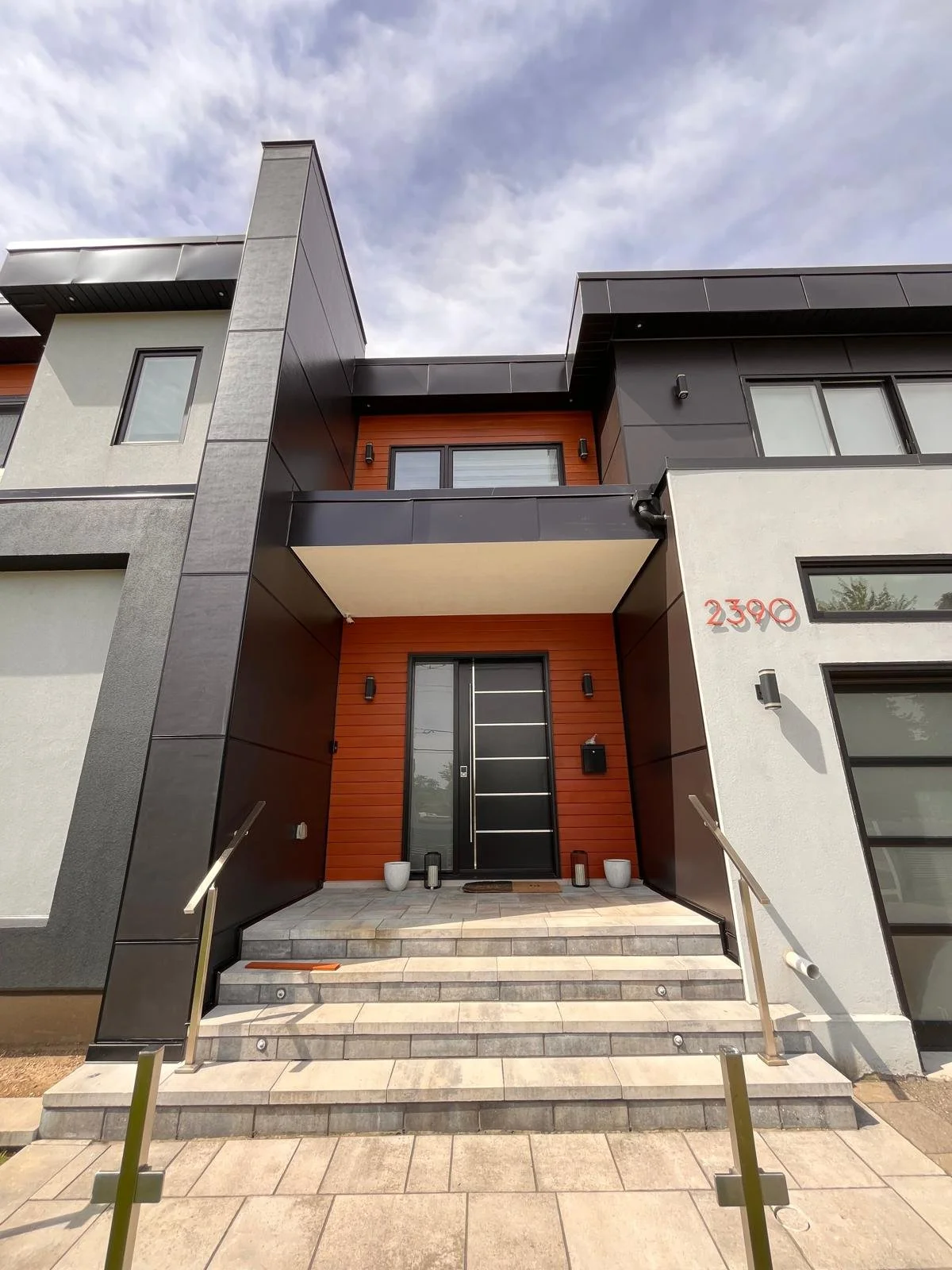 Luxury home where we installed James Hardie fiber cement panels with Aluminum Light Trims. 24 gauge flat lock metal cladding.