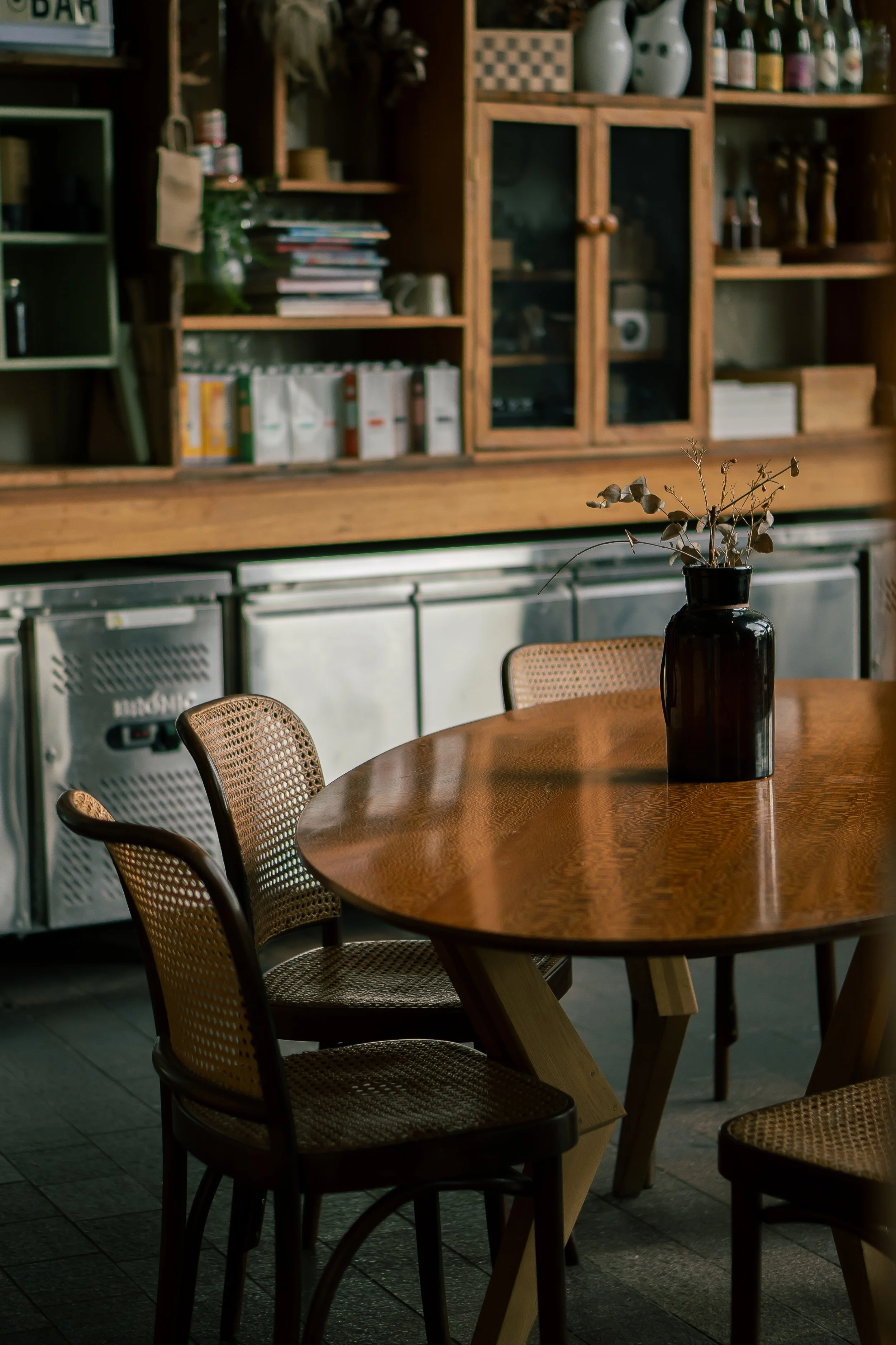 Oval table in a cafe, with rattan seating
