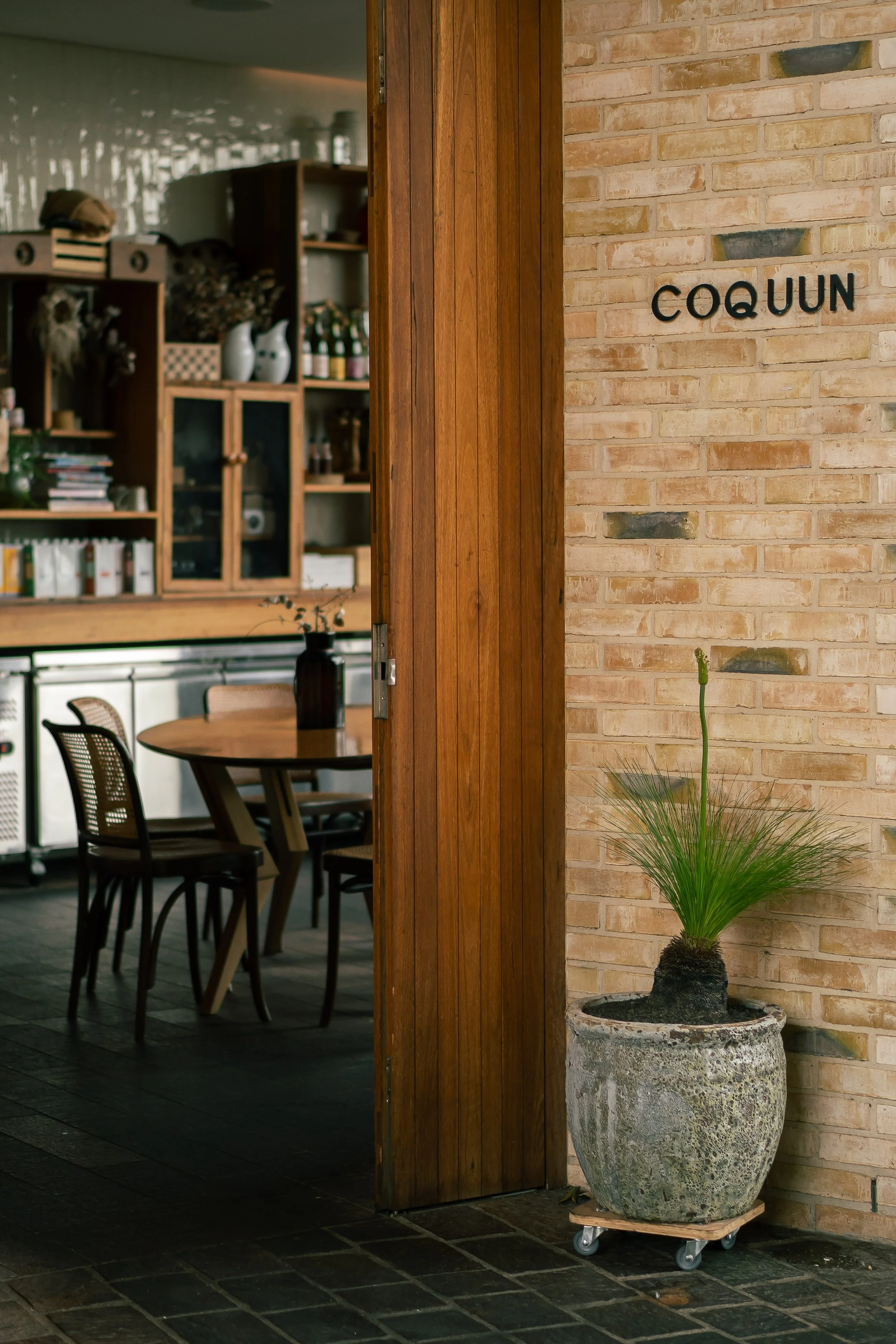 Entry to a cafe, with a peak of internal decor. 
