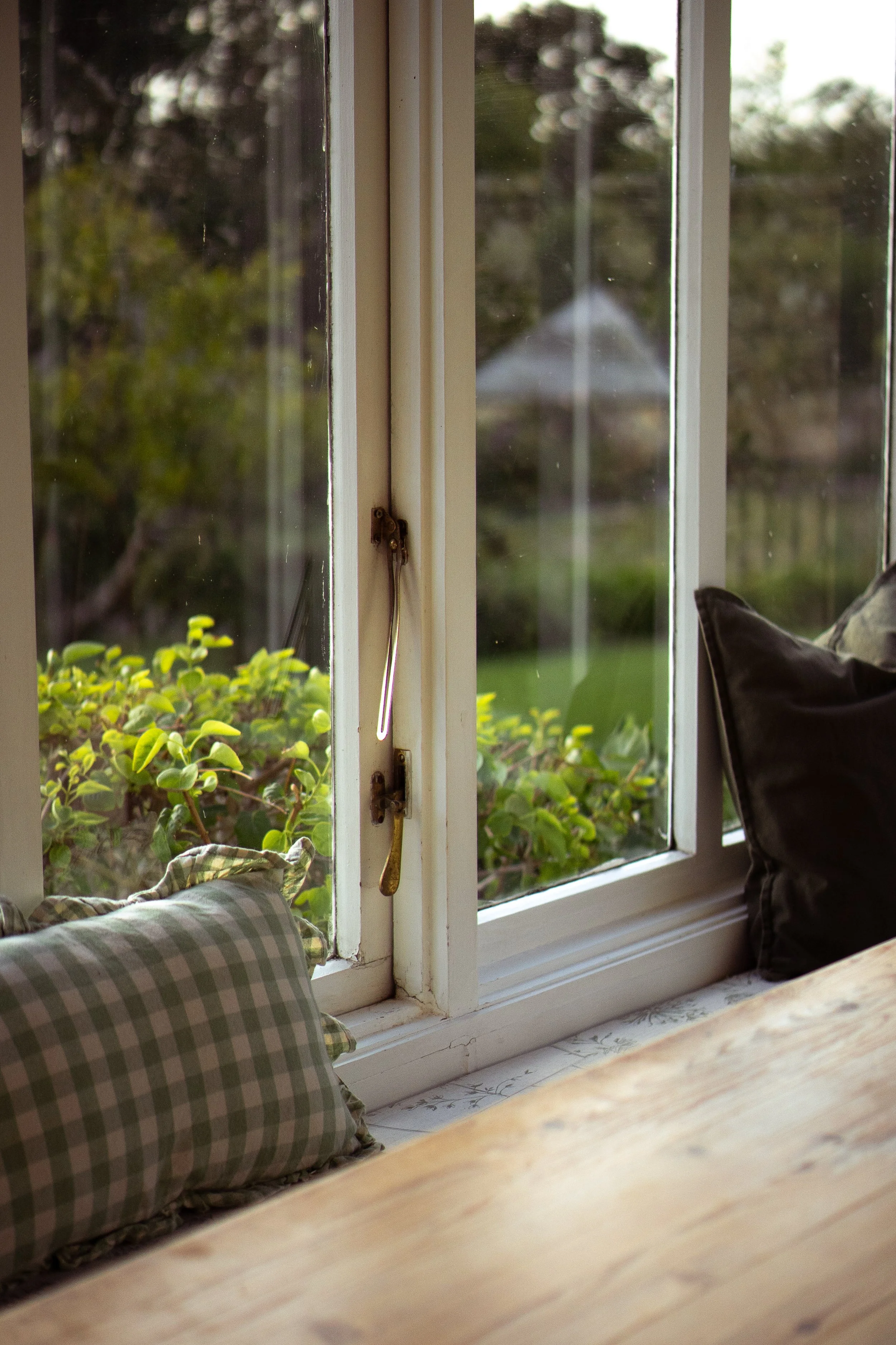 Window seat in a manor house looking over a garden