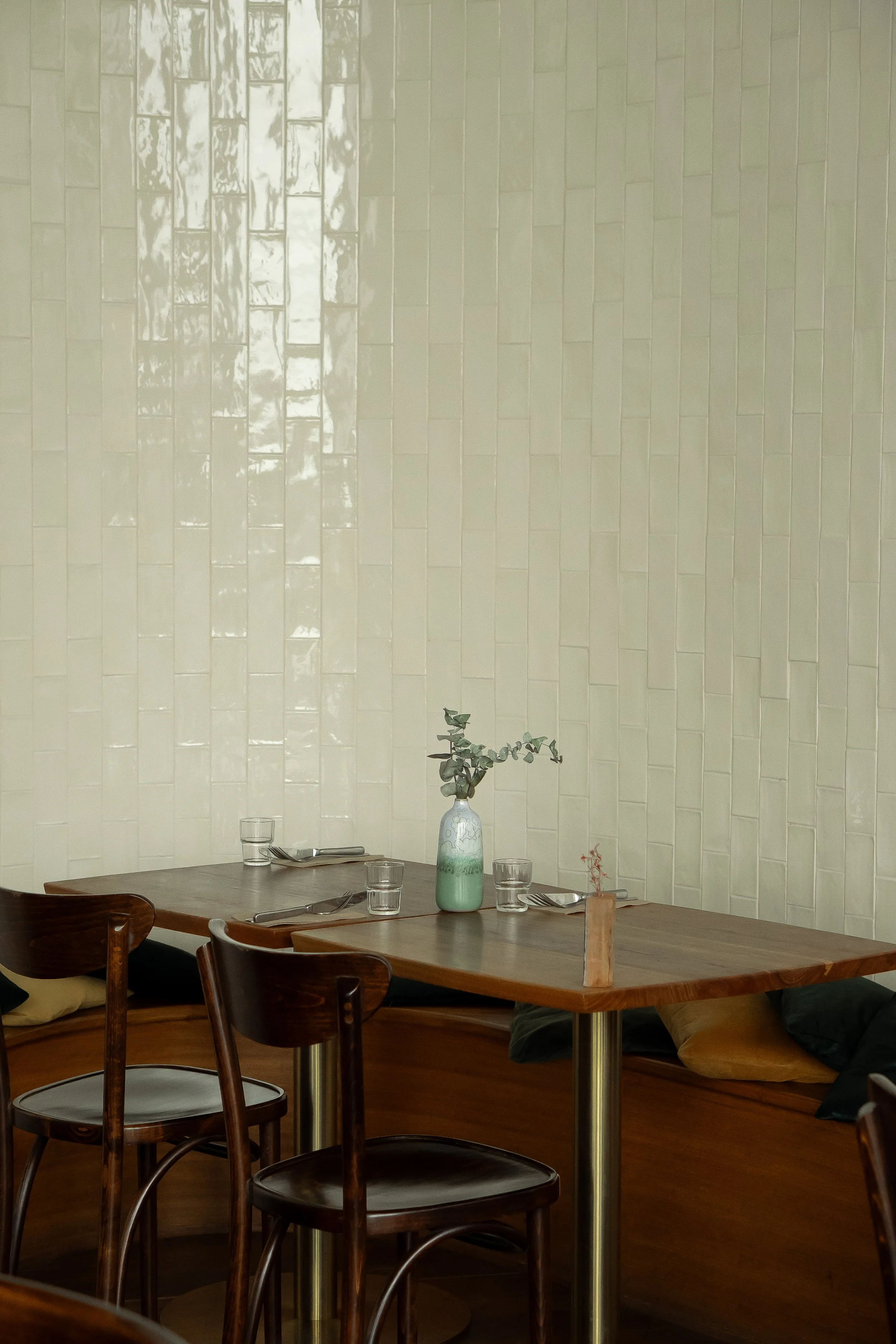 table in the corder of a restaurant, tiled walls 