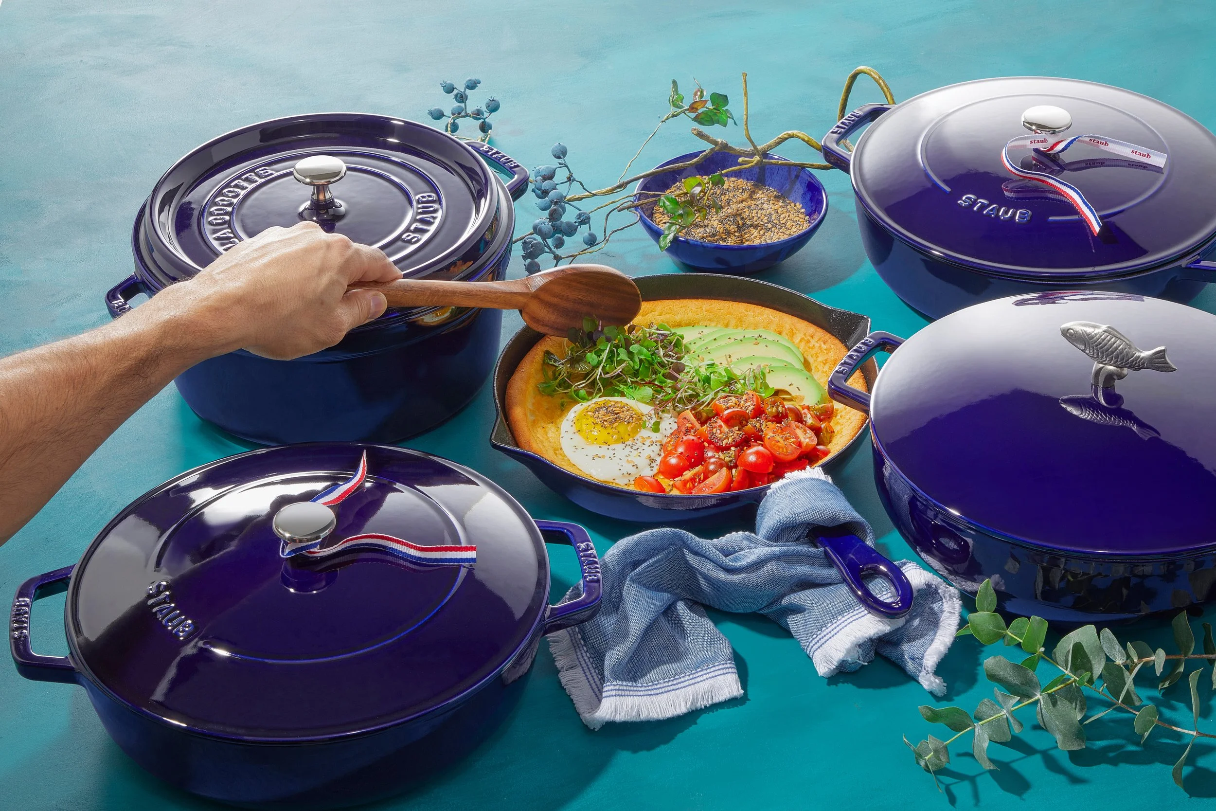 Blue cooking pots, some with fish or 