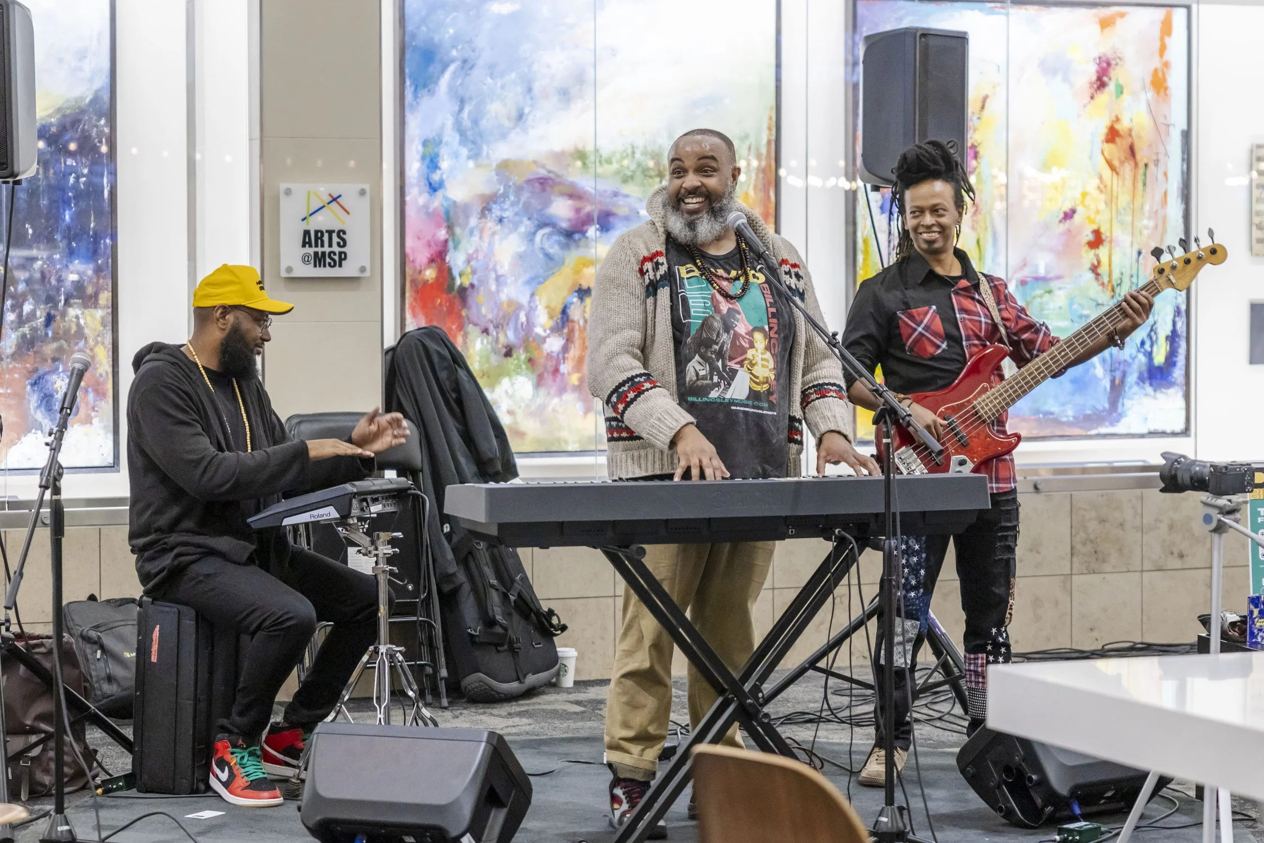 Drummer, Pianist, and Bass player in the main area of MSP Airports Terminal 1