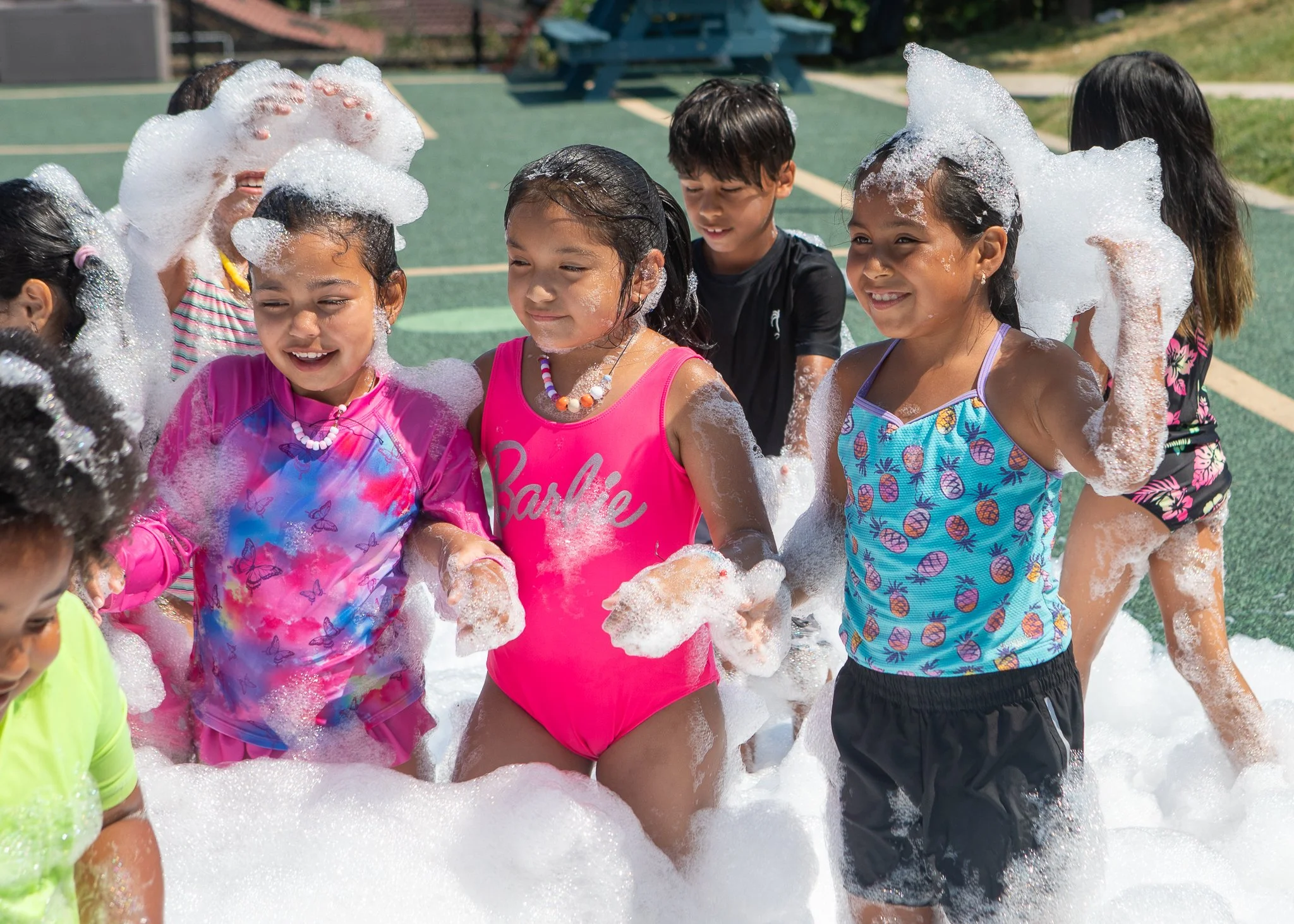 Colorful soap bubbles floating against a dark background.