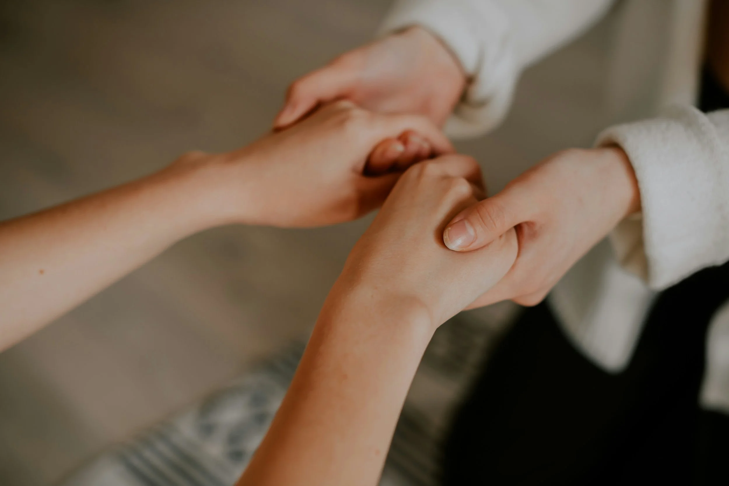 Two women holding hands representing wholeness and healing for Christian women